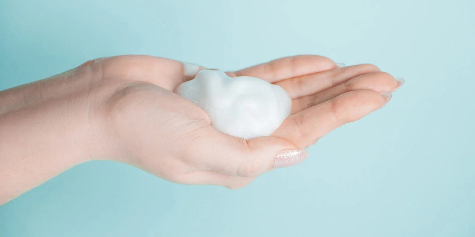 Him with a dab of hand sanitizer foam in his palm