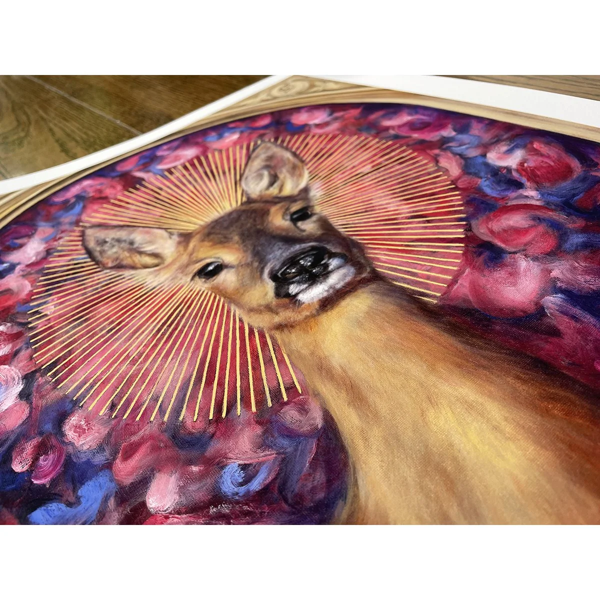Detail of a giclee print of a roe deer doe with a sunburst halo against a background of rose petals. Limited edition prints available to buy.
