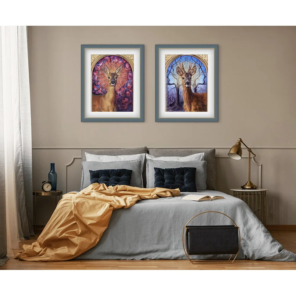 Giclee art print of a male roe deer with a radiant halo against a background of mirrored winter trees - framed and hanging on the wall in a bedroom. Print available to buy.
