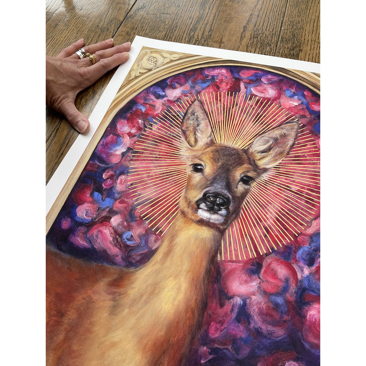 Detail of a giclee print of a roe deer doe with a sunburst halo against a background of rose petals. Limited edition prints available to buy.