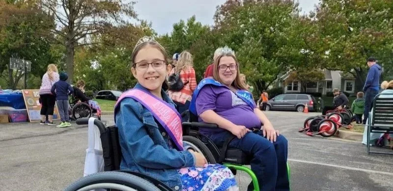 Isabel and Hilary smiling at an outdoor event