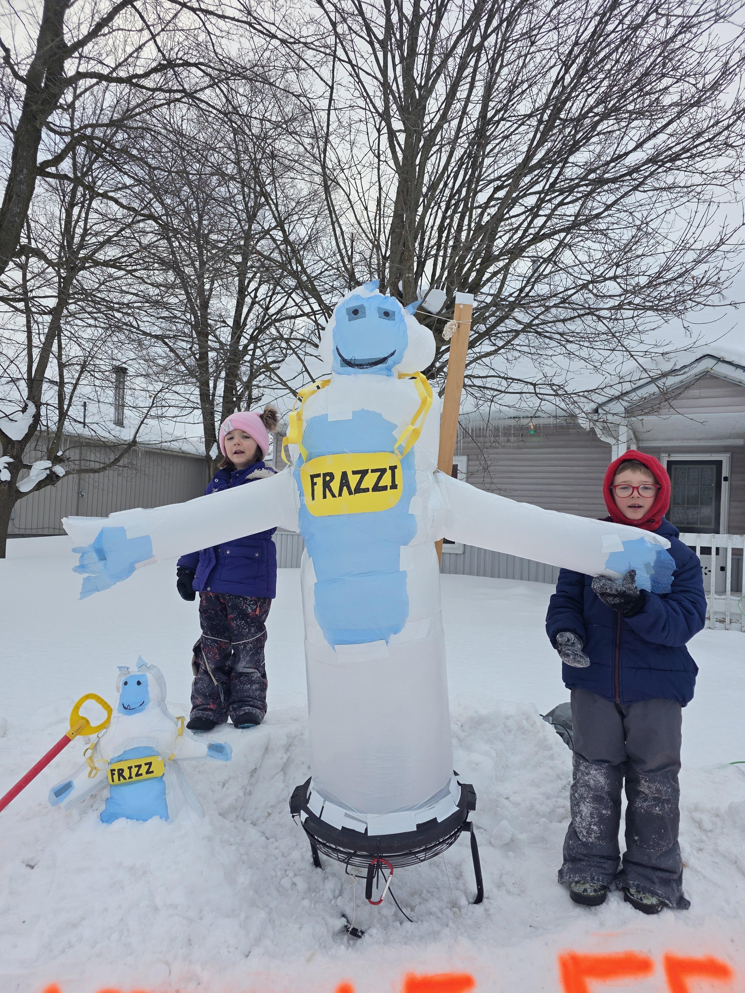 Children showing off their Frazzi sculpture