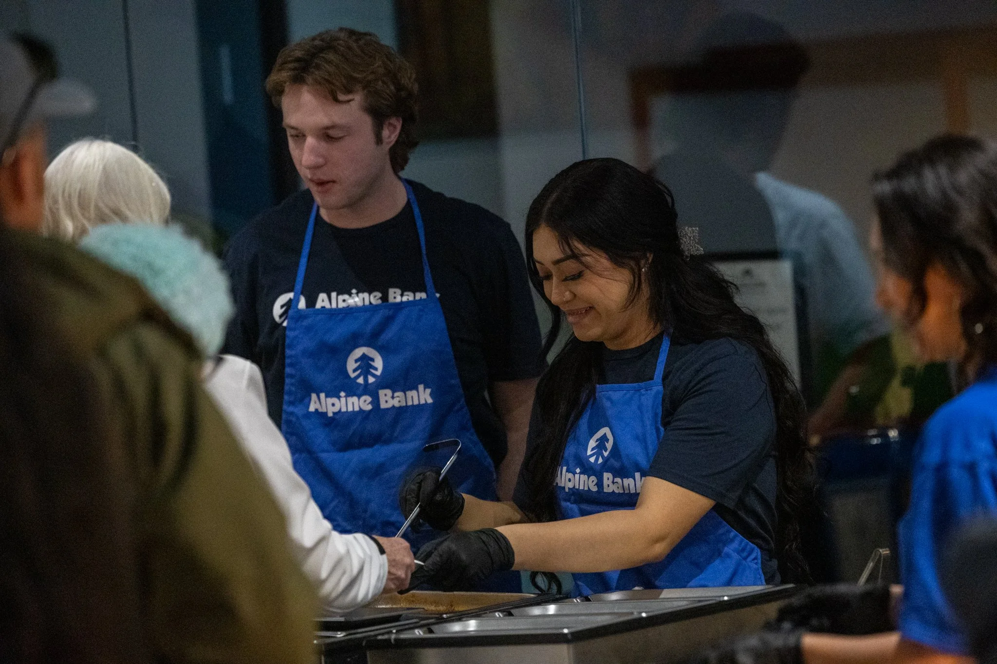 Alpine Bank volunteers serving chili at Bluecorn Cafe & Mercantile