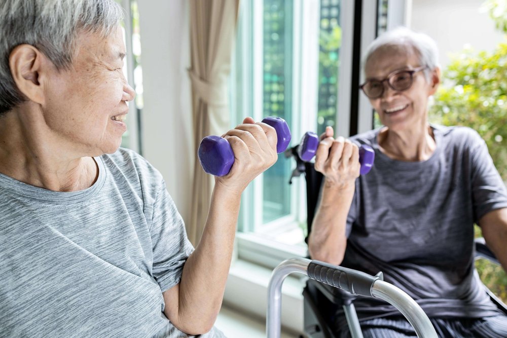 Elderly man and woman working out with hand weights