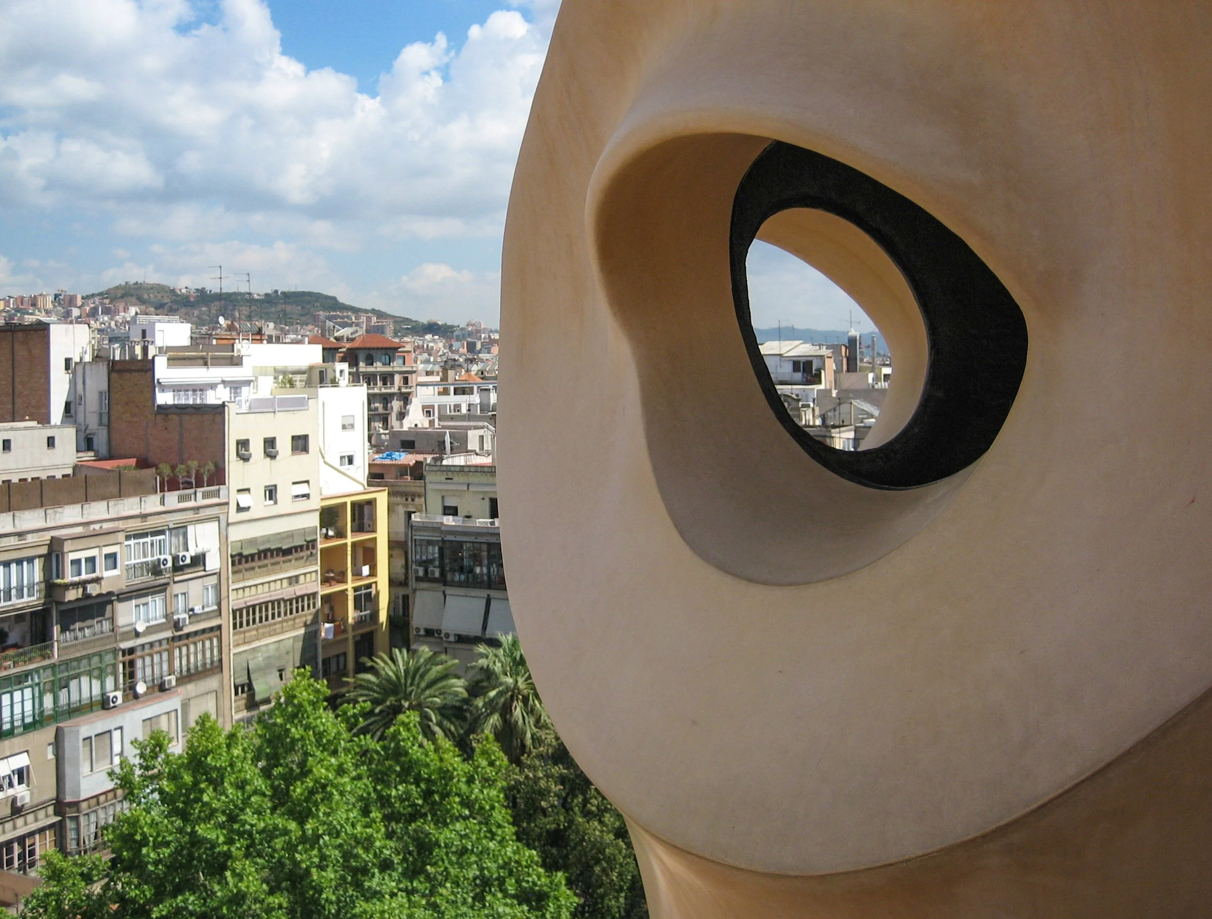 Barcelona-Gaudi-Rooftop-and-City.JPG