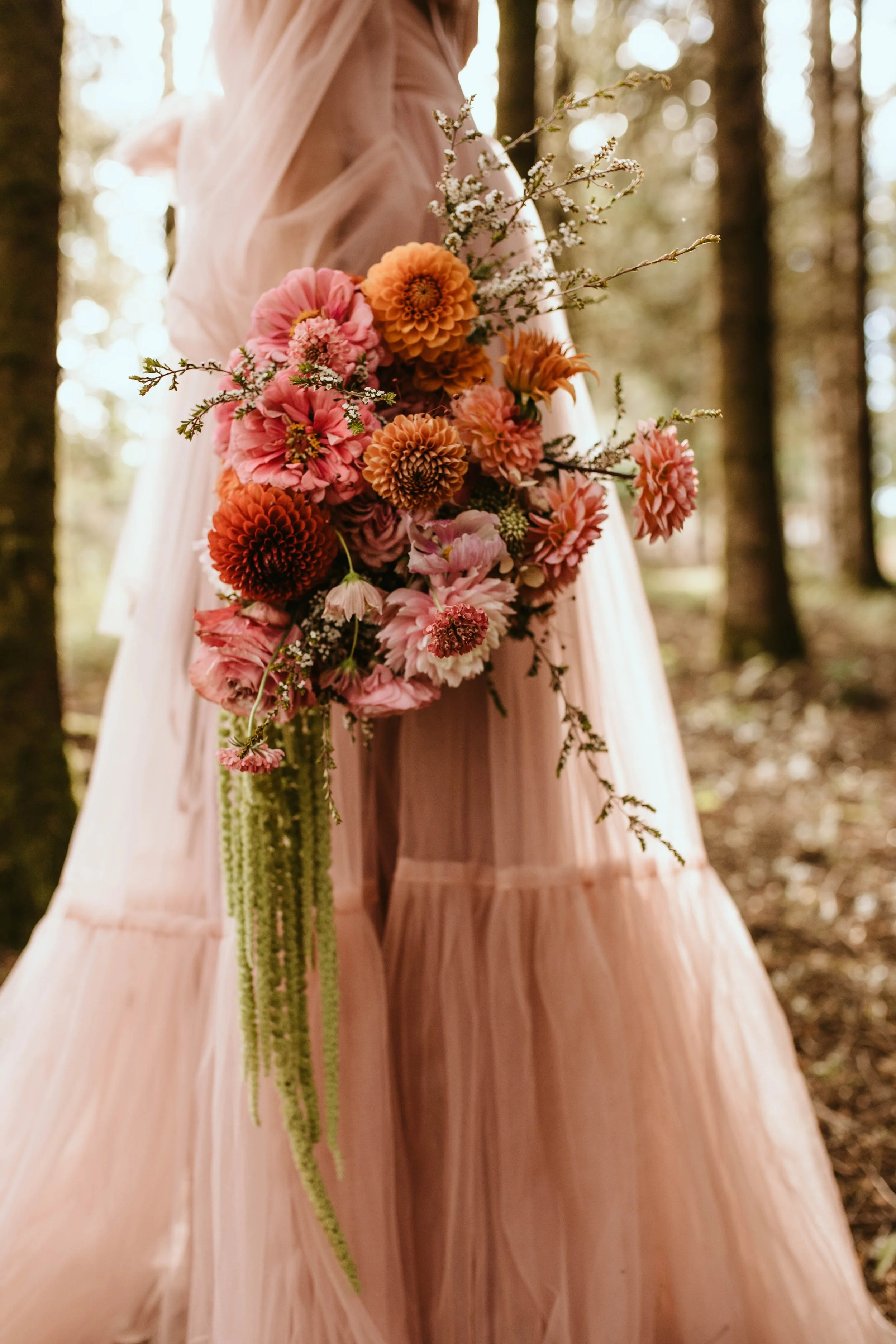 Garden-style bridal bouquet with peach, coral and blush flowers with airy greenery in Portland Oregon Wedding Florist | Merry and Flora
