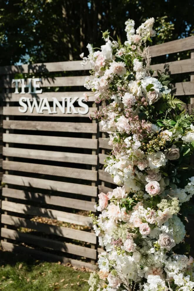 Garden-style wedding silk floral installation with blush and ivory flowers