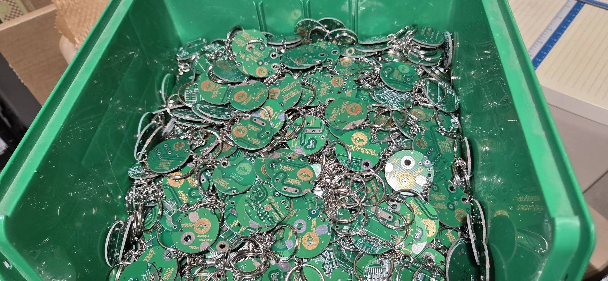 Hundreds of upcycled  circuit board in a container key chains