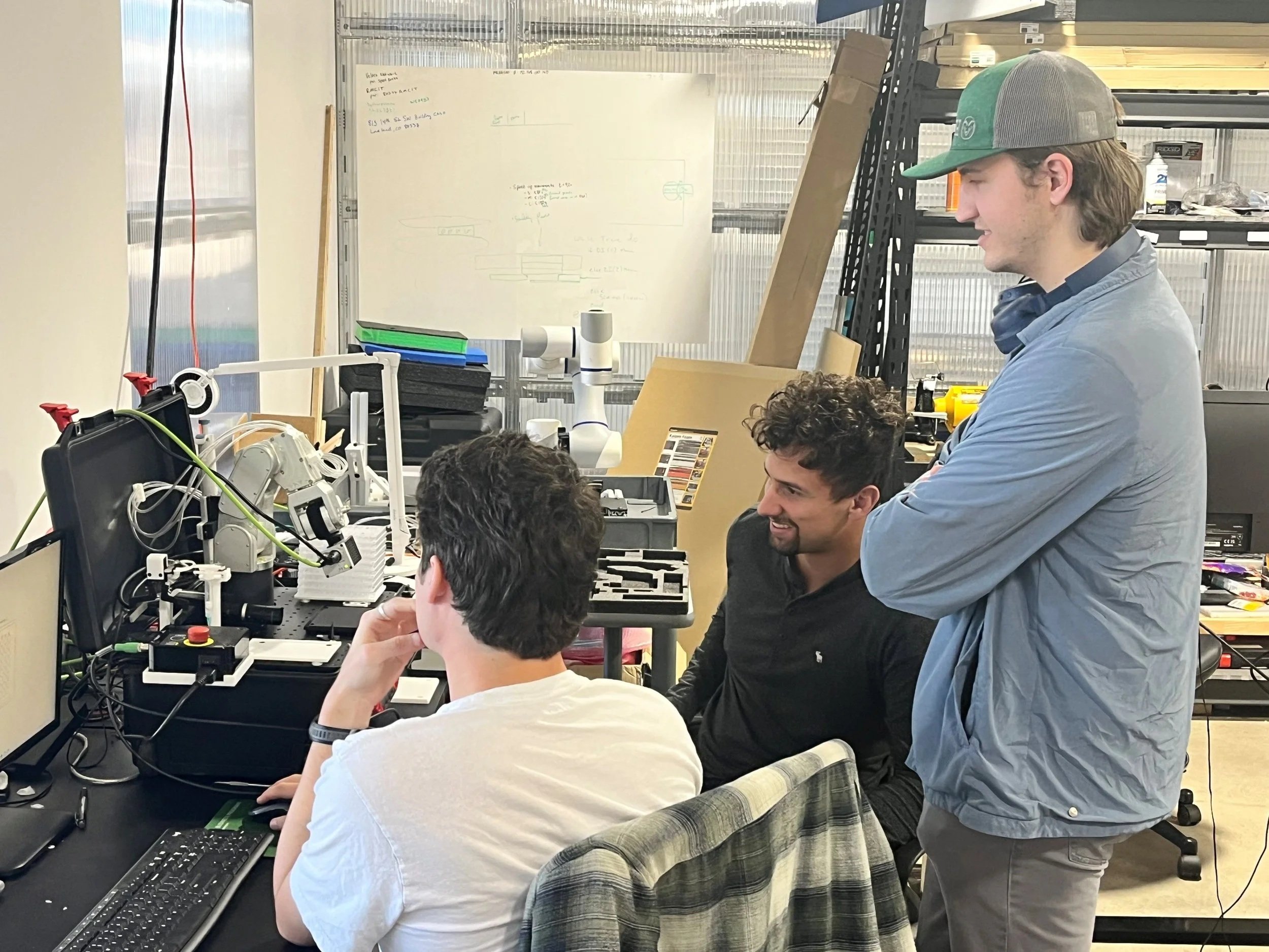 Three engineers working on cobot