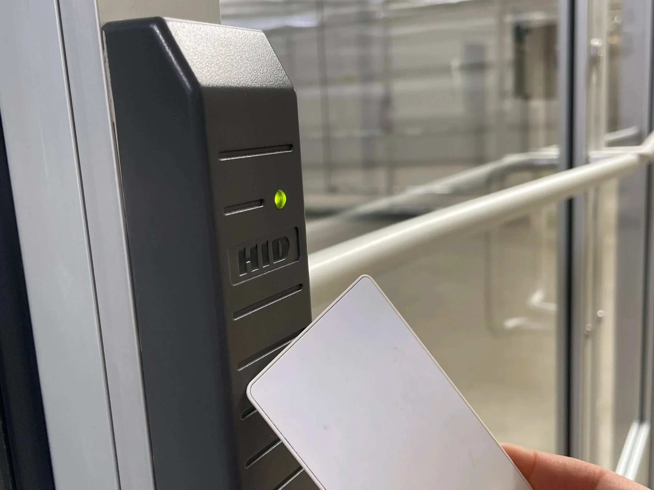 Badge striking against badge reader to one of the private spaces