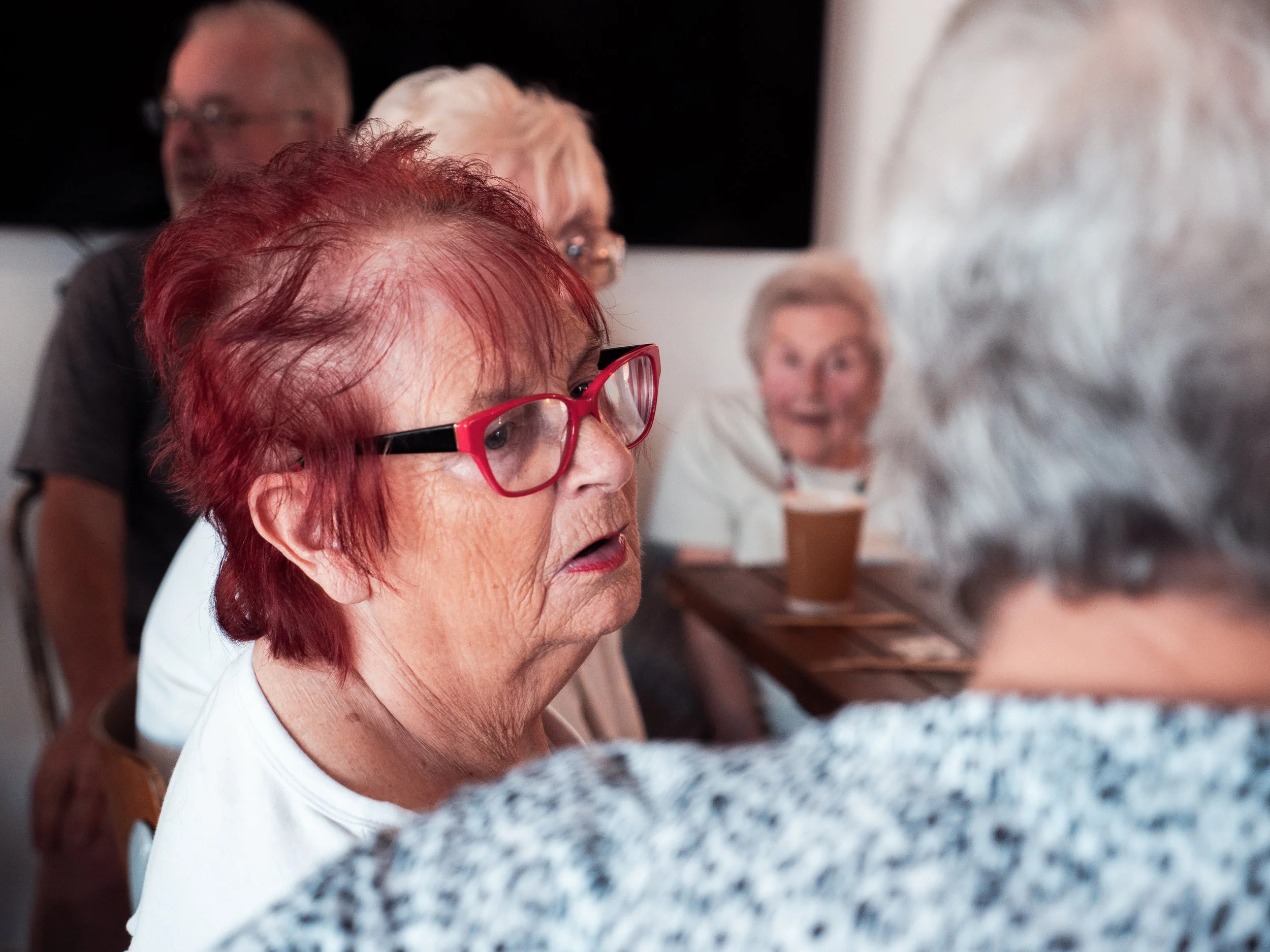 Older woman with red glasses in cafe
