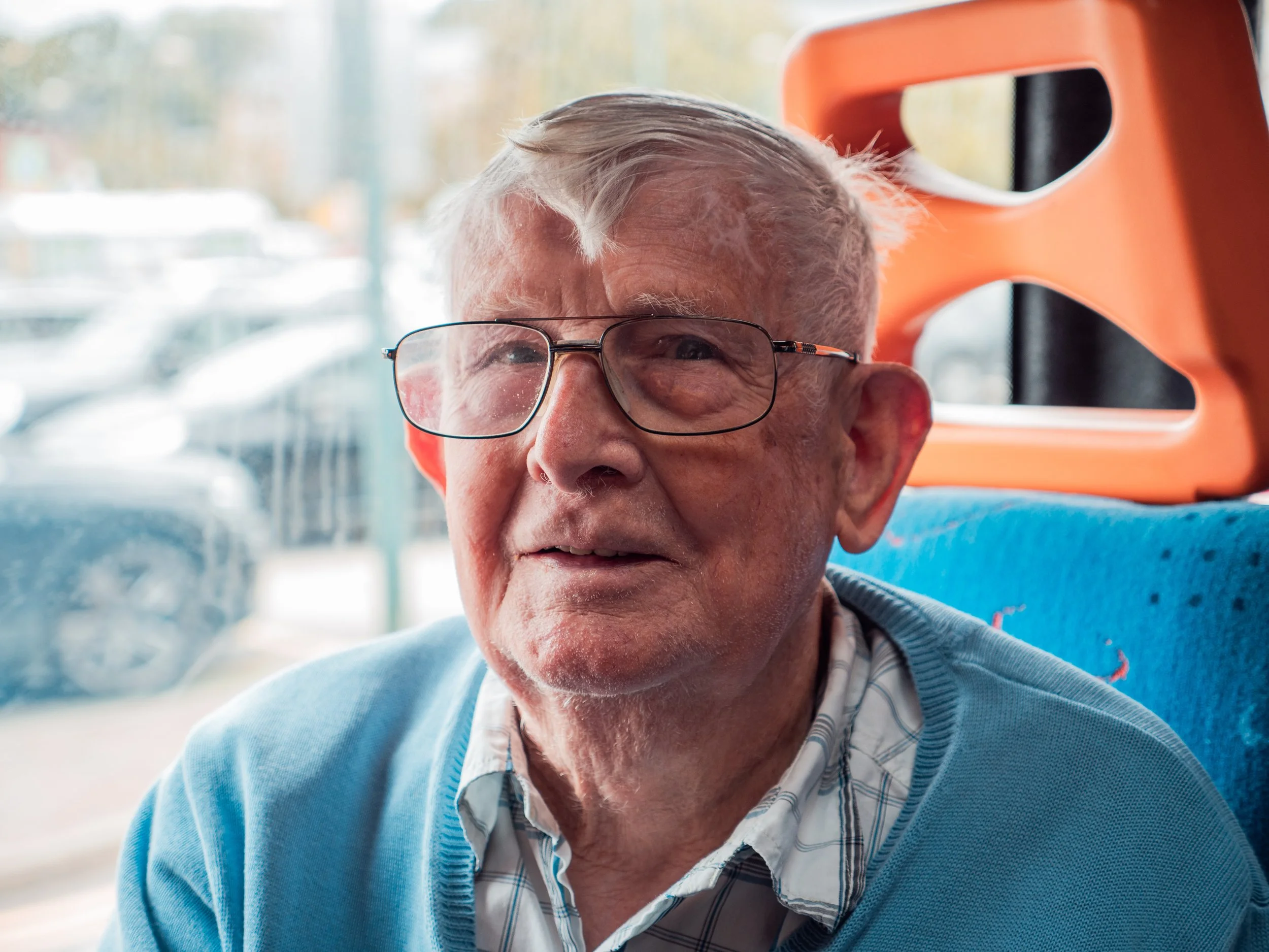 Older man in glasses on bus
