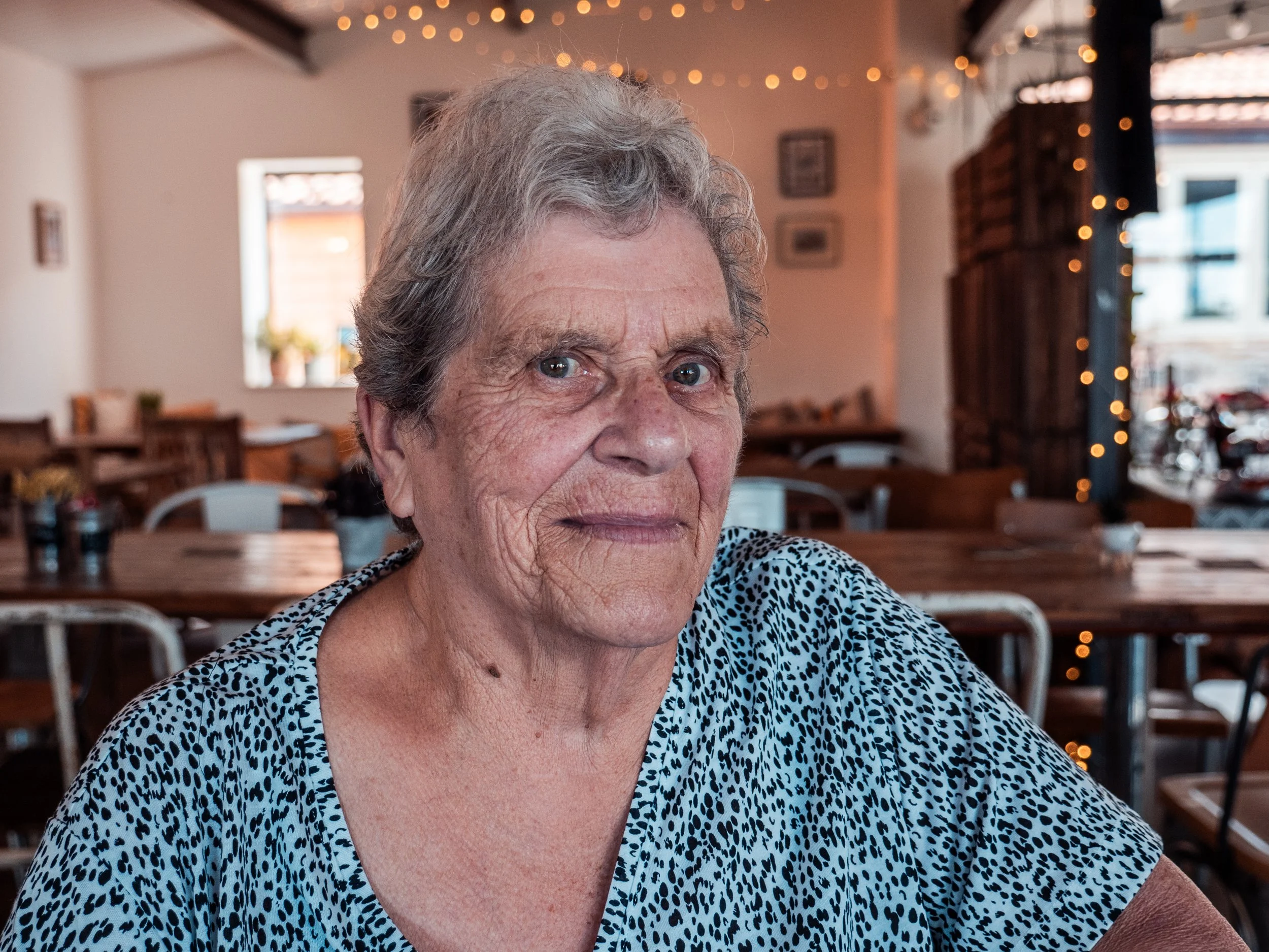 Woman with grey hair in cafe