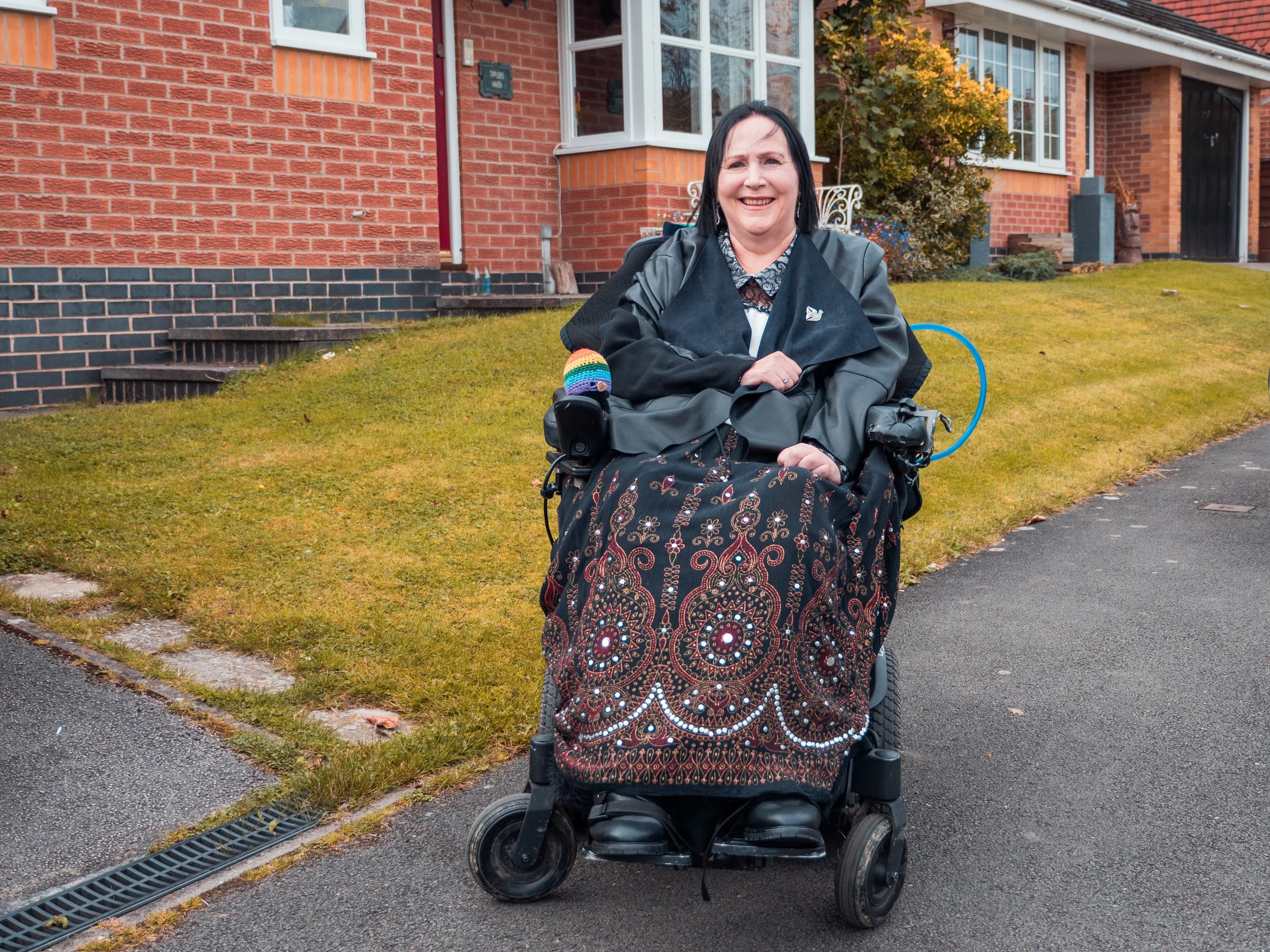 Woman in wheelchair in black leather jacket