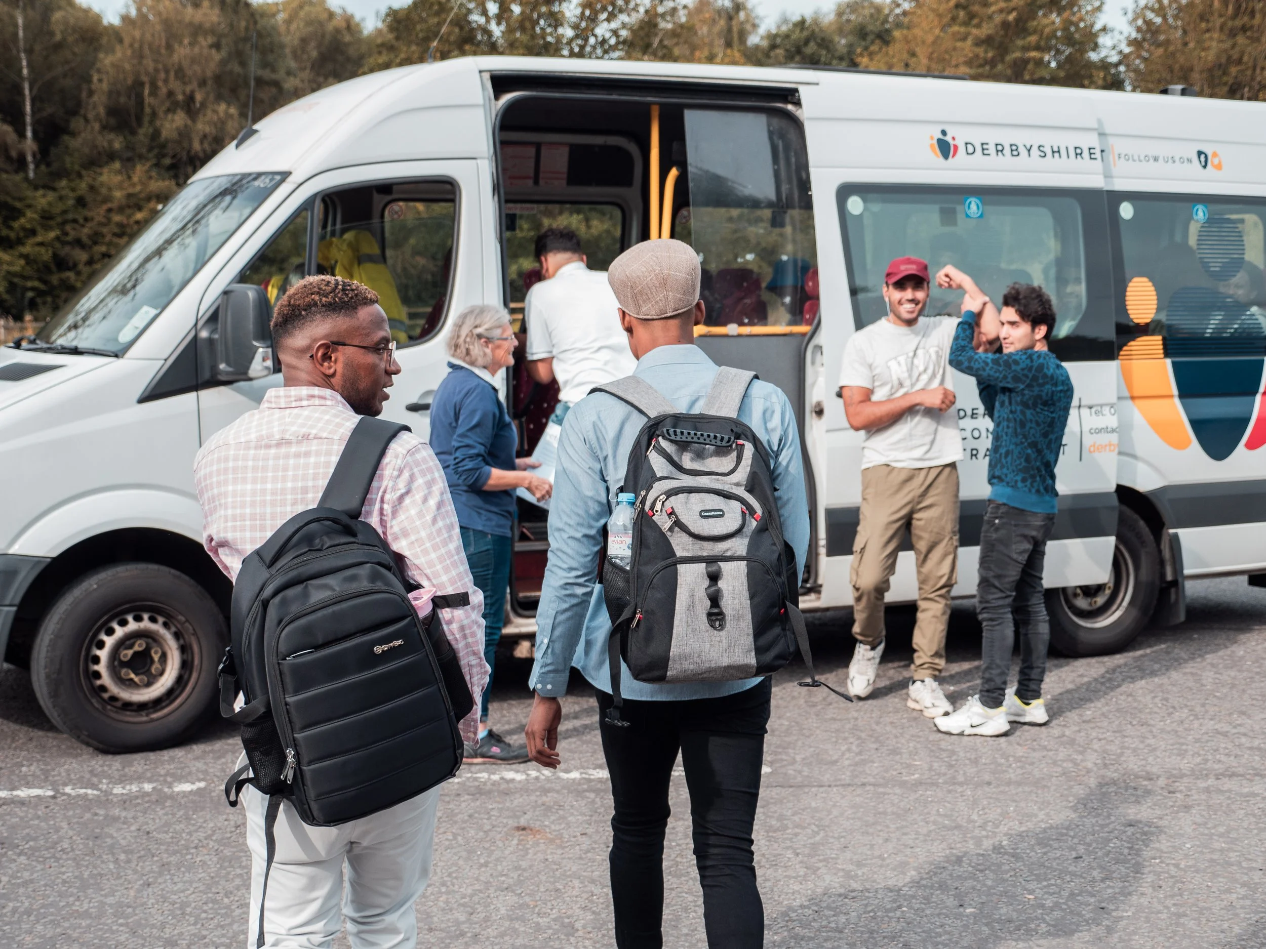 Group of young men getting on community bus