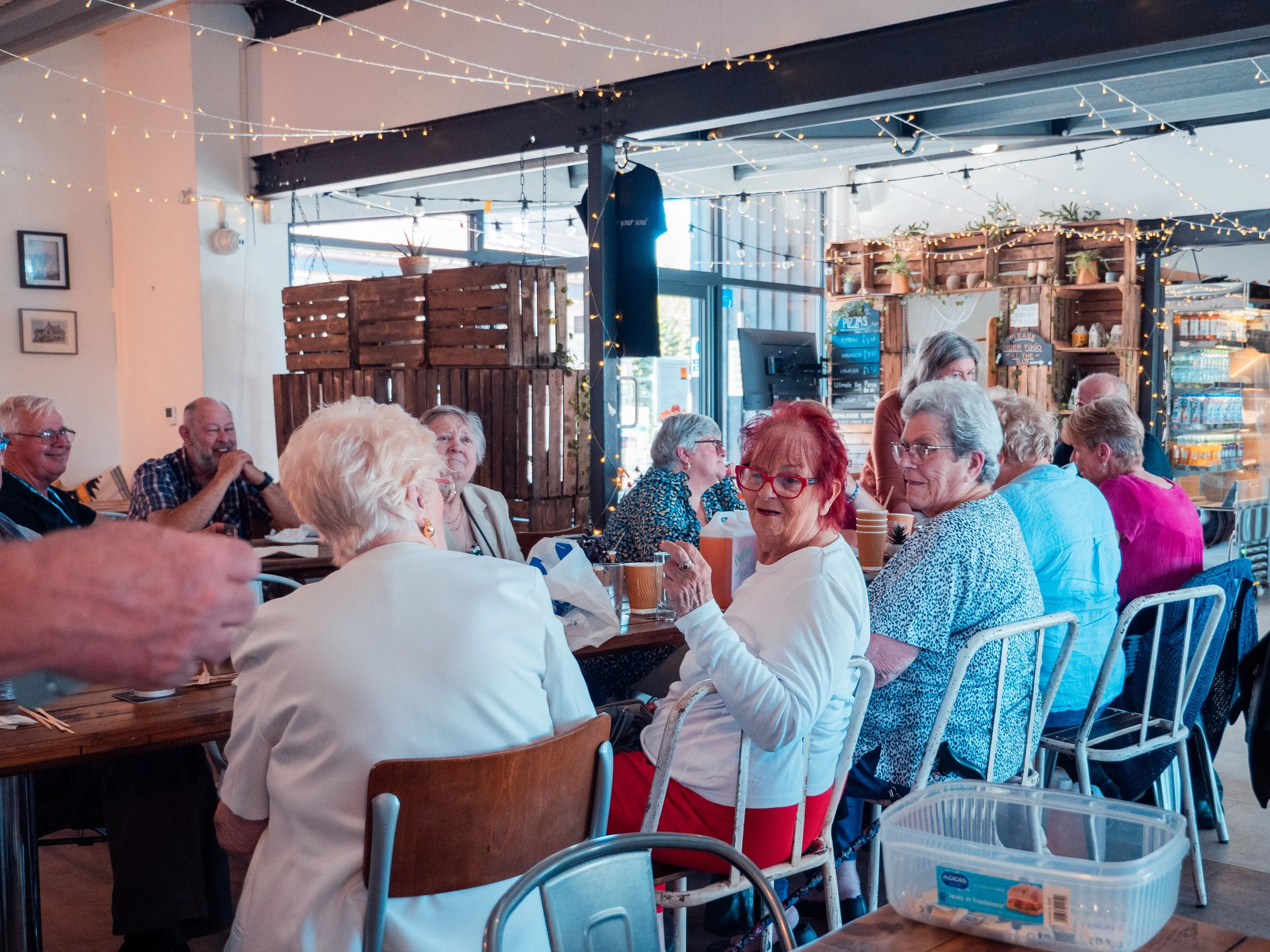 A group of people socialising in cafe