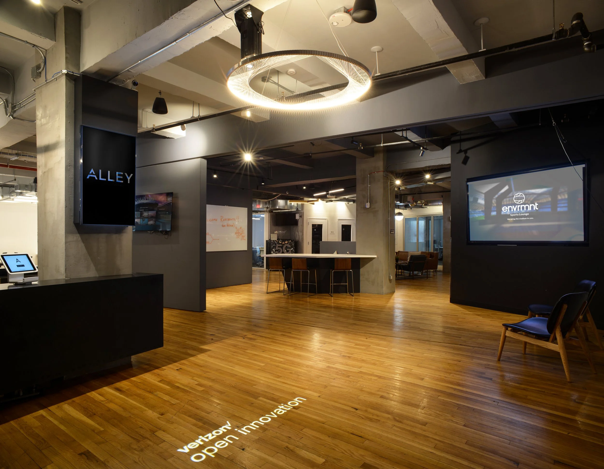 Modern office interior with "Alley" and "Envrmnt" signage