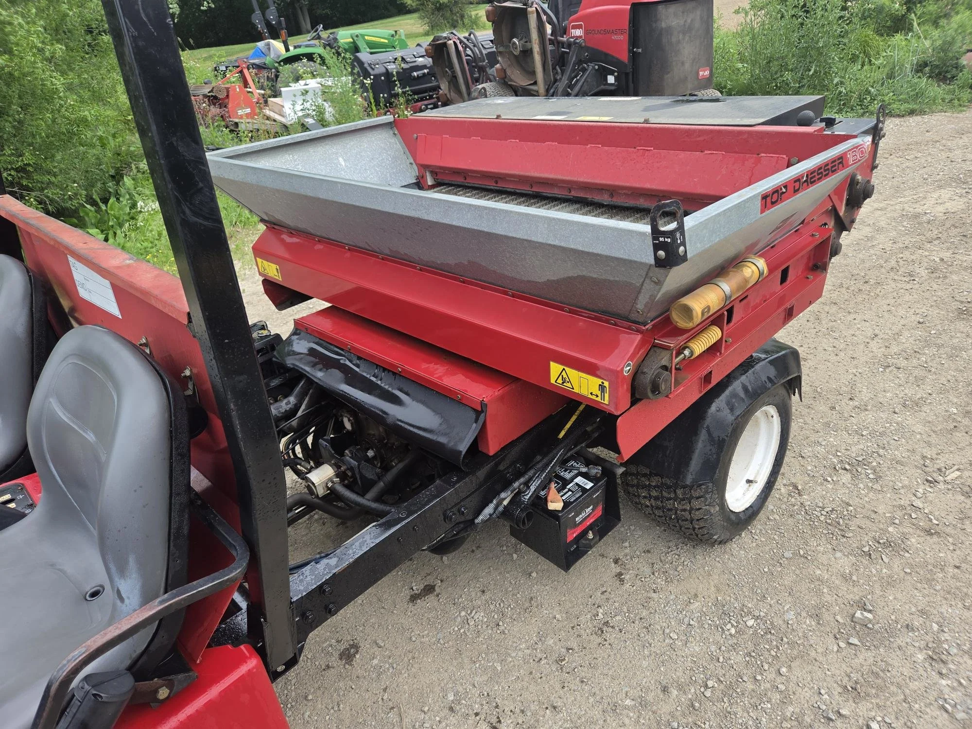 2013 Toro HDX gas watercooled unit with Toro topdresser and a bed