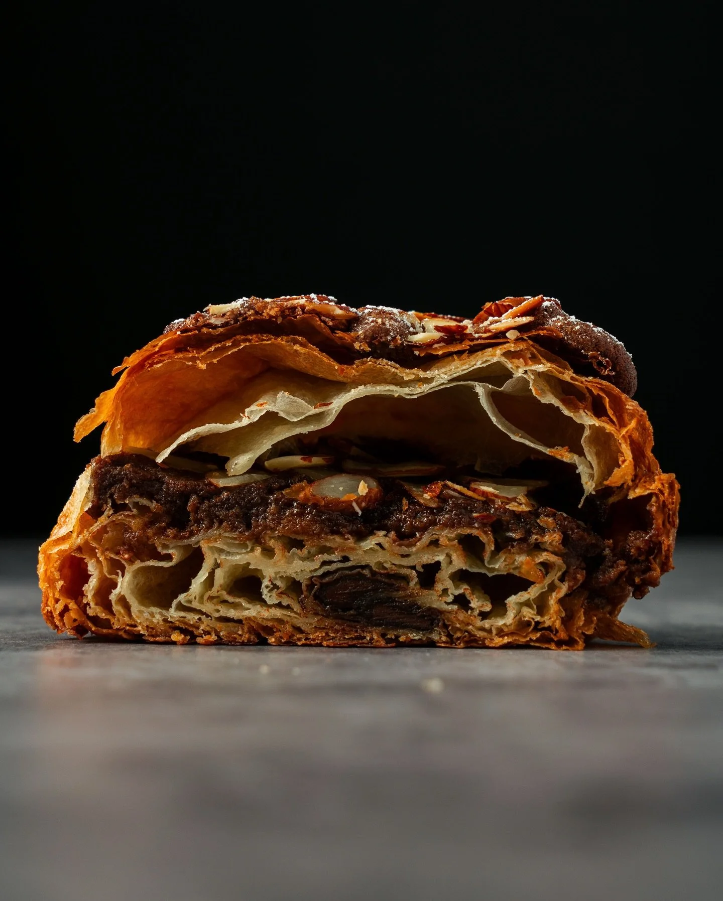 CHOCO ALMOND CROISSANT

Flake. Crunch. Melt. Repeat.

Dark chocolate cream and almond praline tangled up between buttery folds, topped with chocolate batons and toasted almonds. The kind of cross-section that makes you rethink breakfast priorities.

