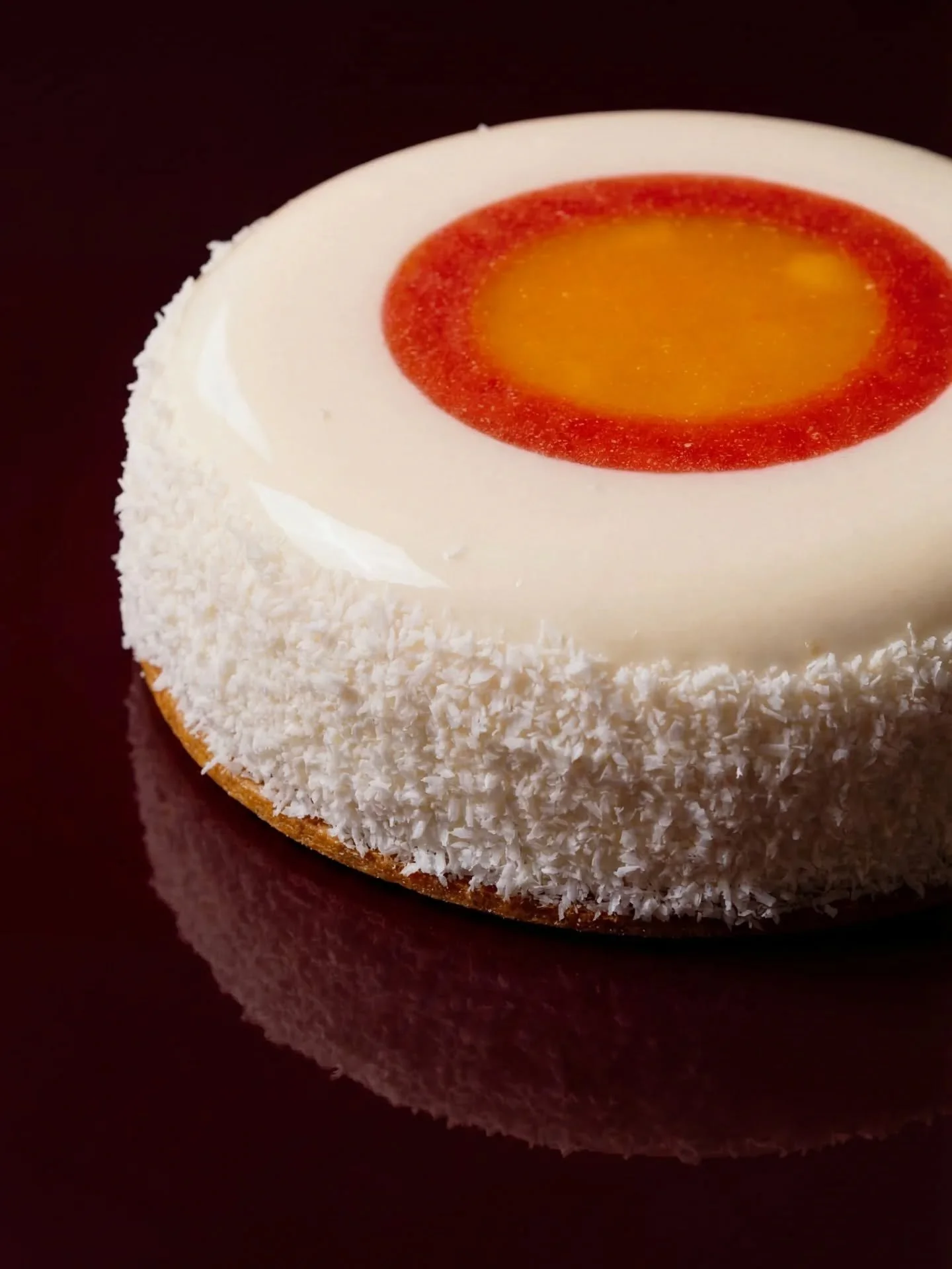 Coconut Halo Mousse Cake ✨🥥🍓

A light coconut mousse cake with a bright center of strawberry gel and passion fruit&ndash;mango compote.
Tart, tropical, and balanced with a coconut lime crunch, finished in a mirror glaze with shaved coconut.

Gluten