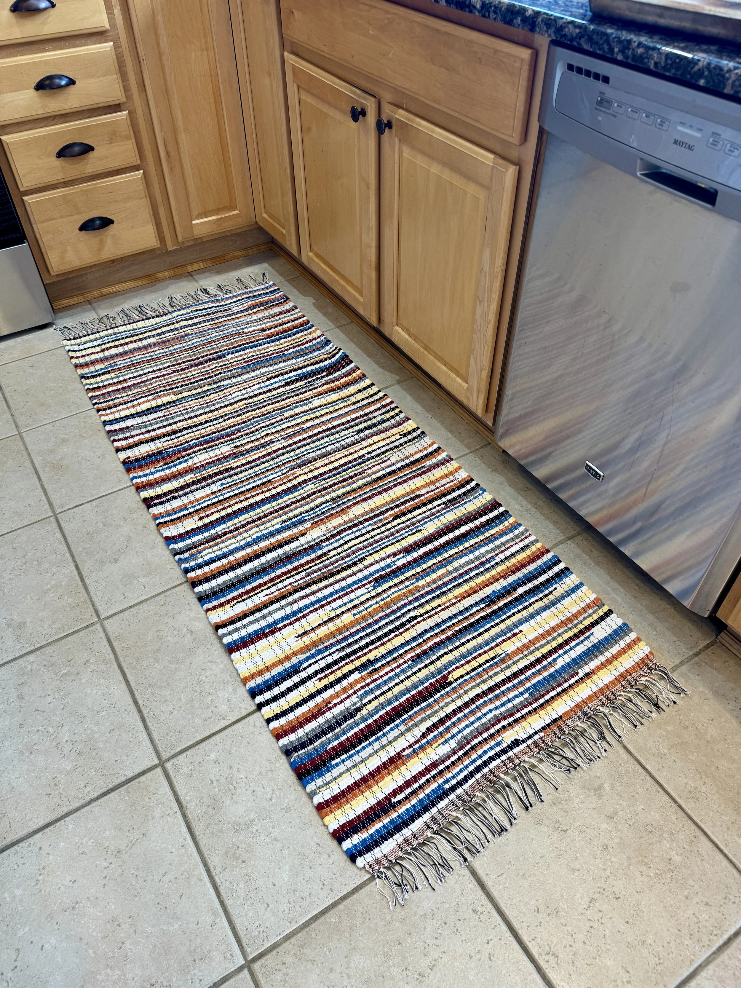 Displayed handmade rag rug in kitchen showing pattern and texture