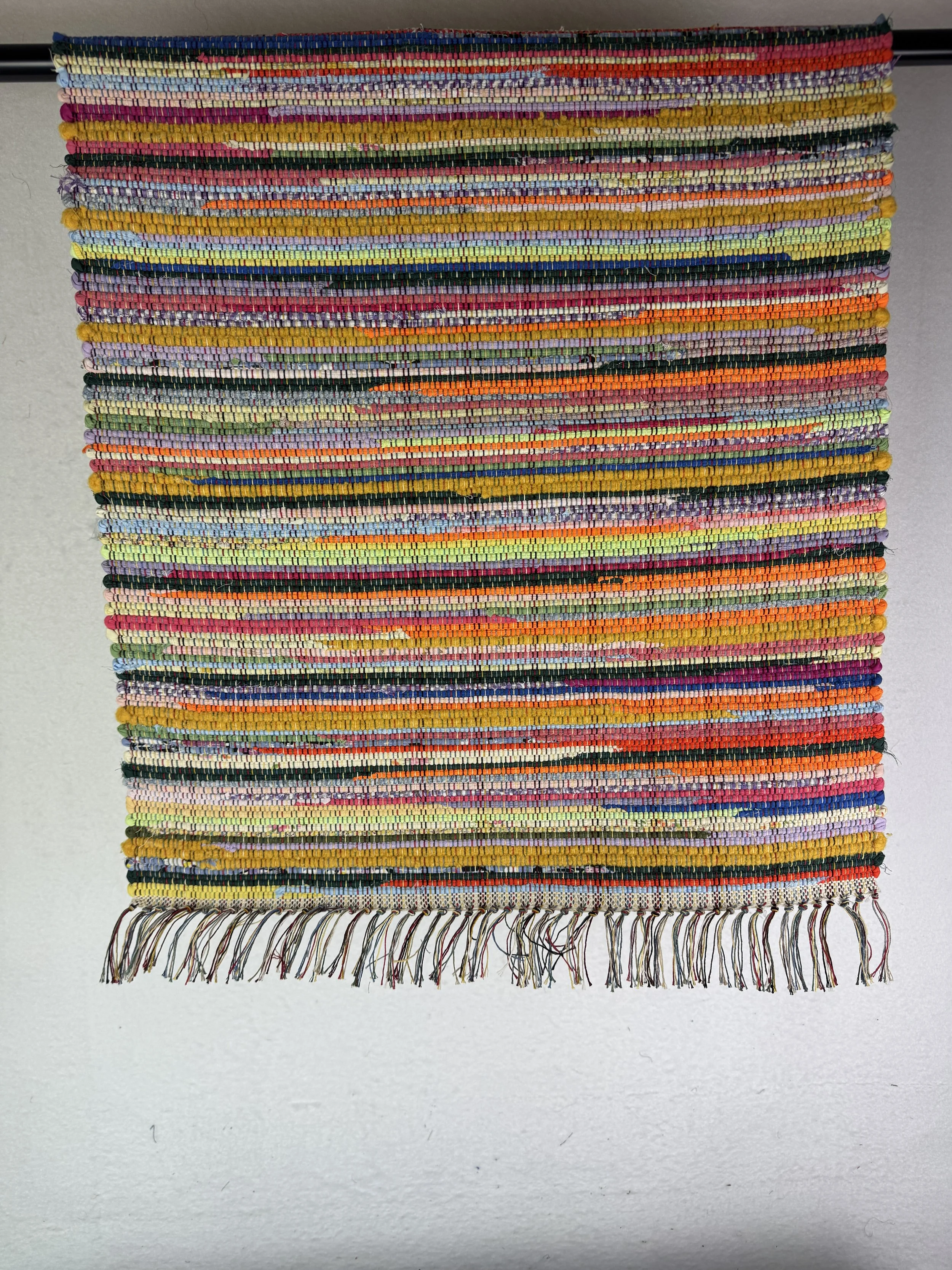 Hanging rag rug showing pattern and texture