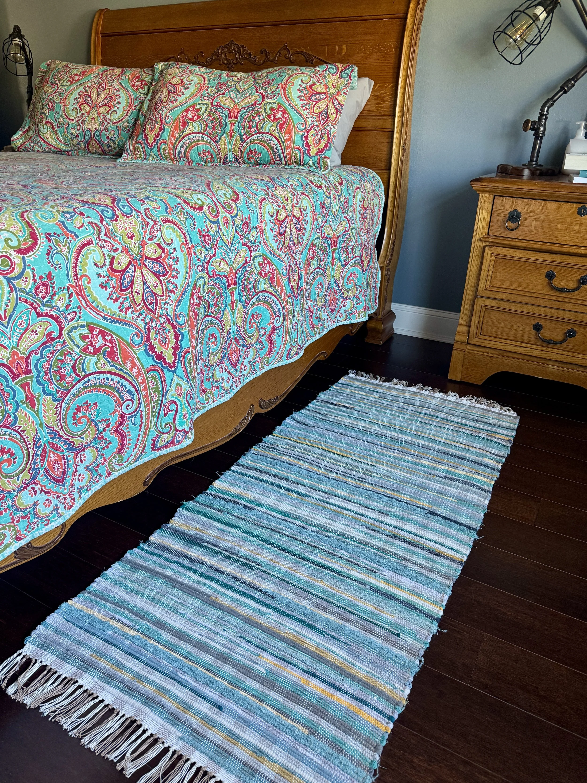 Displayed handcrafted rag rug in bedroom showing pattern