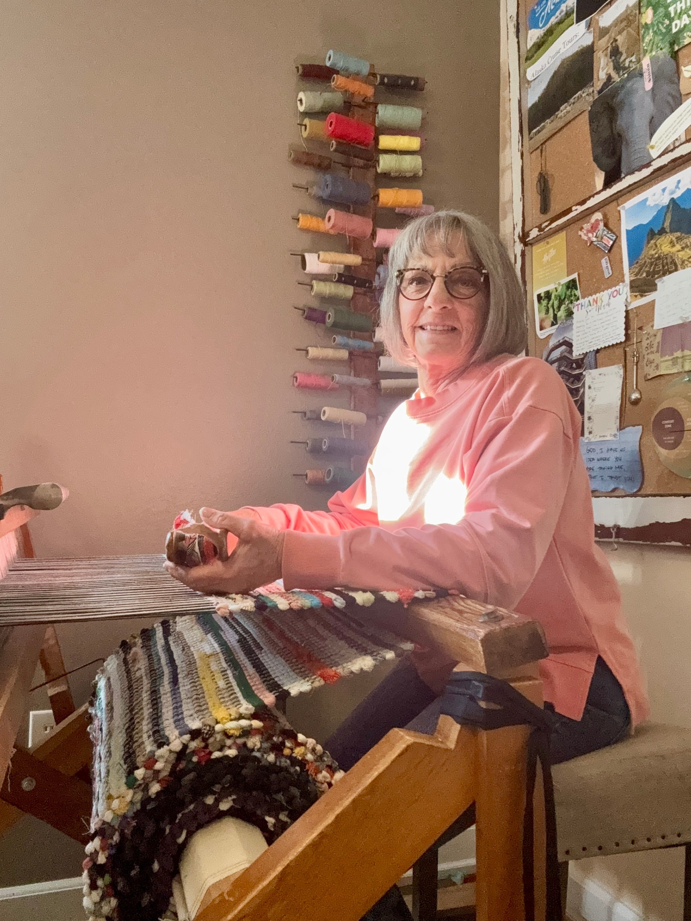 Terry weaving a handmade rug on wooden loom upcycling old clothes and household textiles into rag rugs