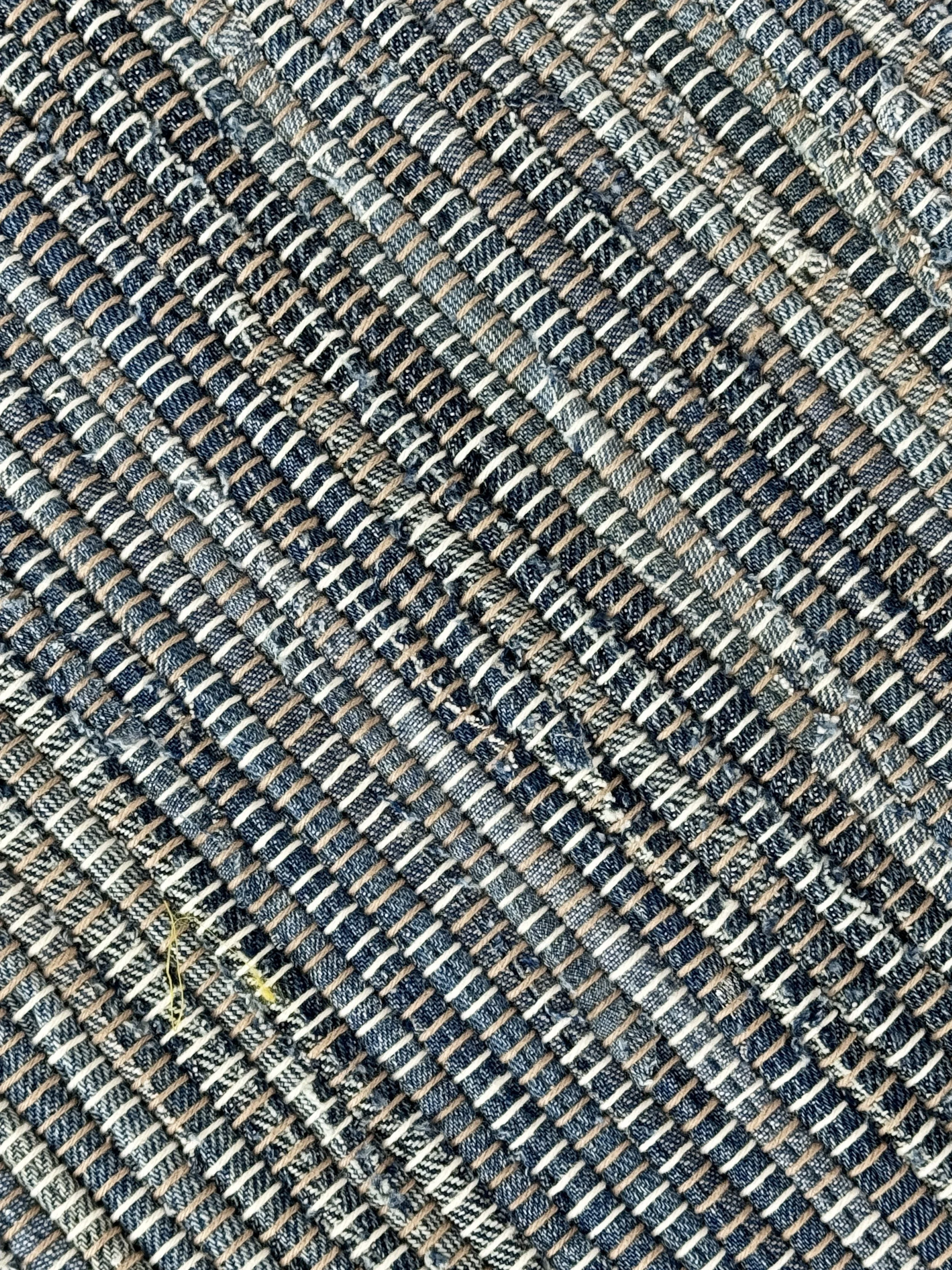 Close up handmade rag rug featuring texture and weave pattern