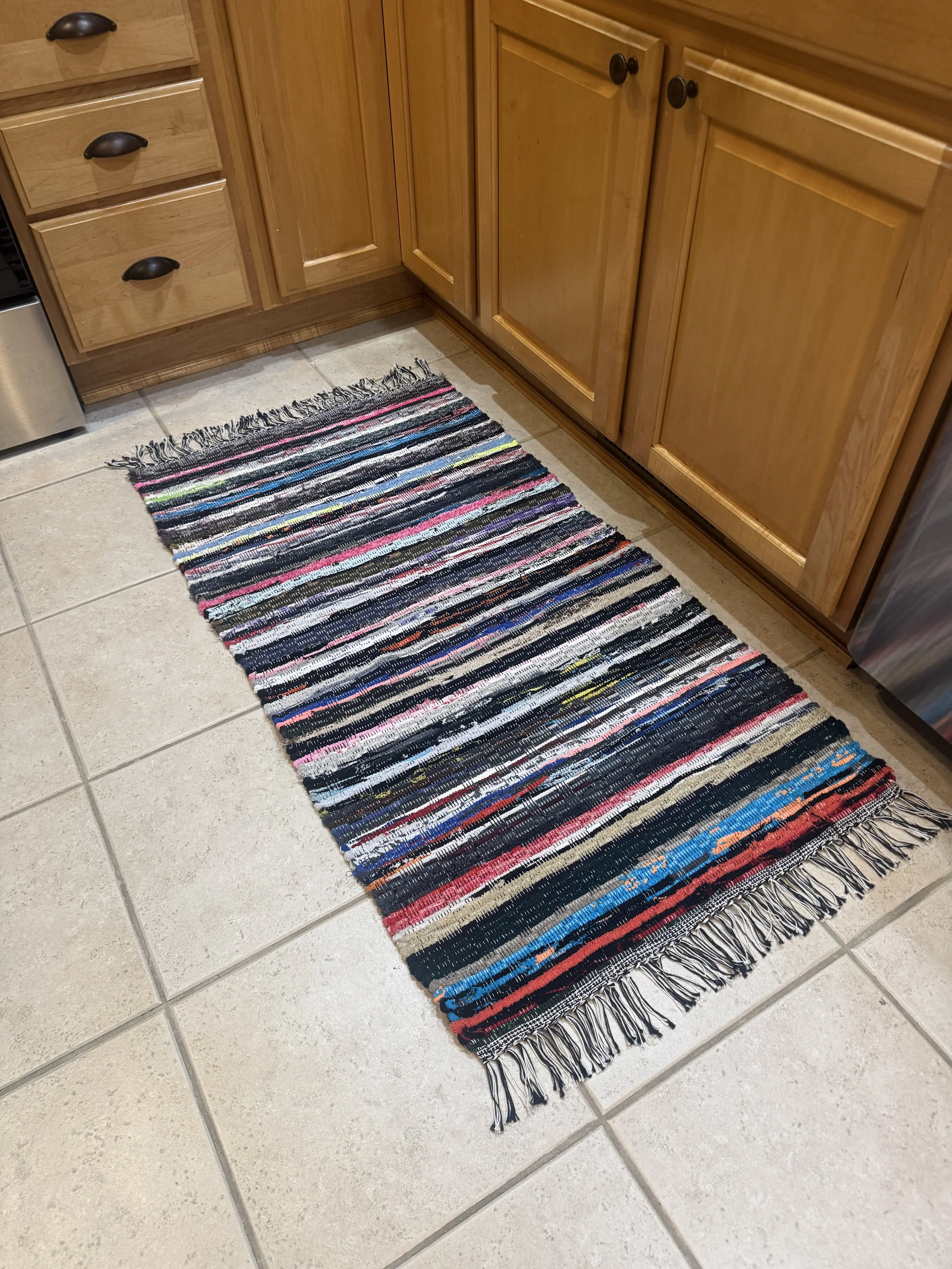 Handwoven rag rug displayed in kitchen showing pattern