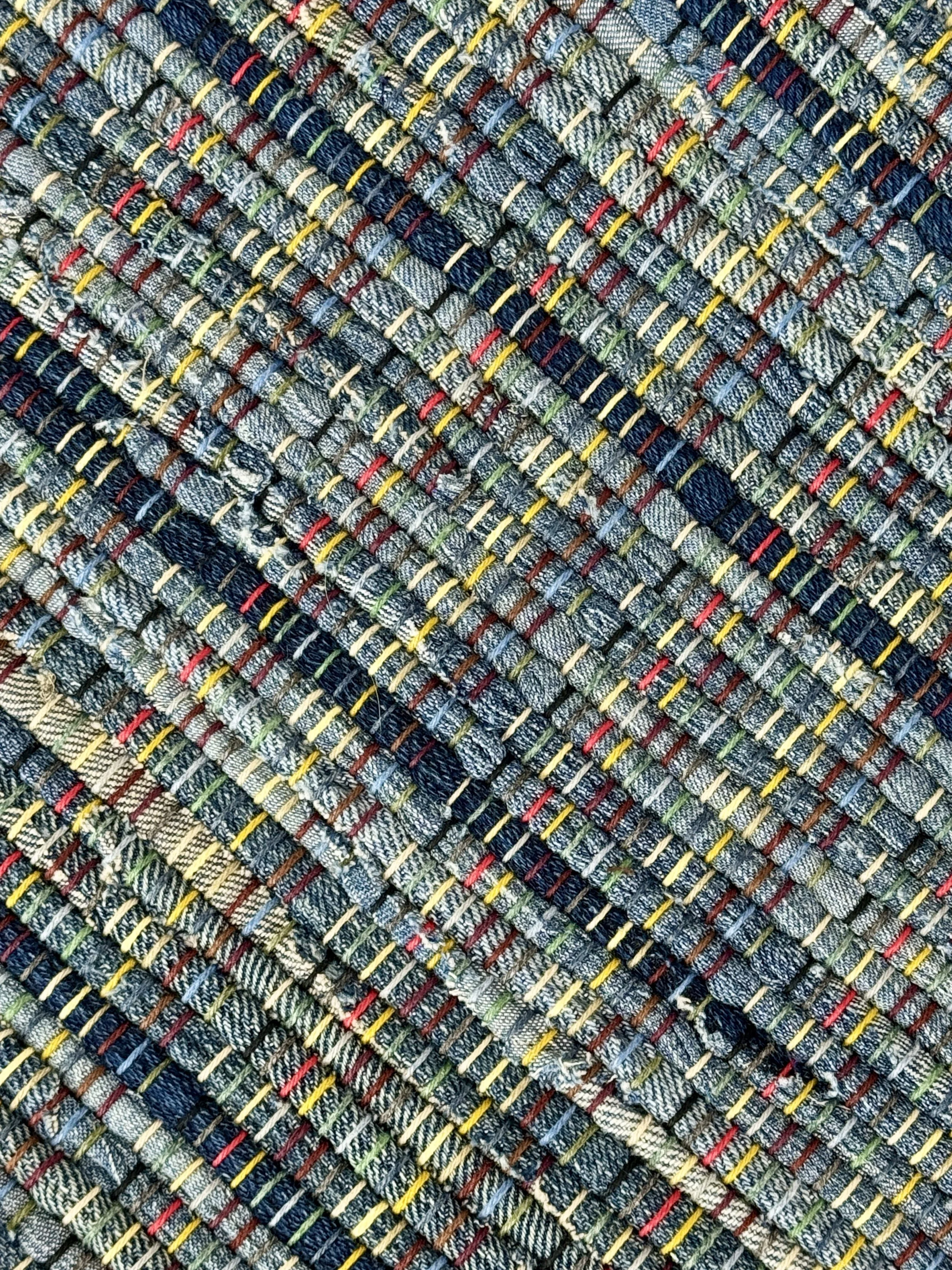 Close up handmade rag rug featuring texture and weave pattern