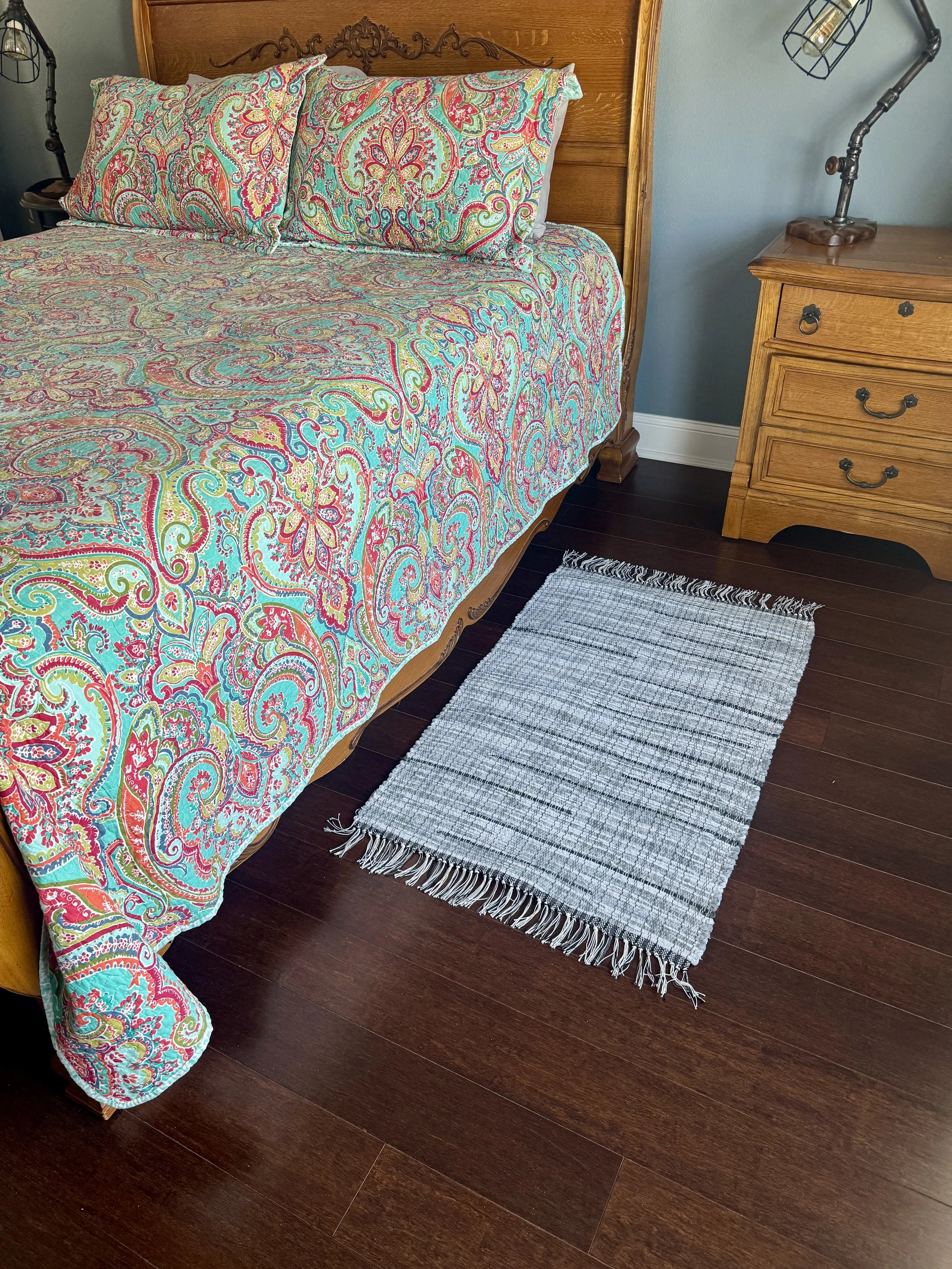 Displayed handcrafted rag rug in bedroom showing pattern