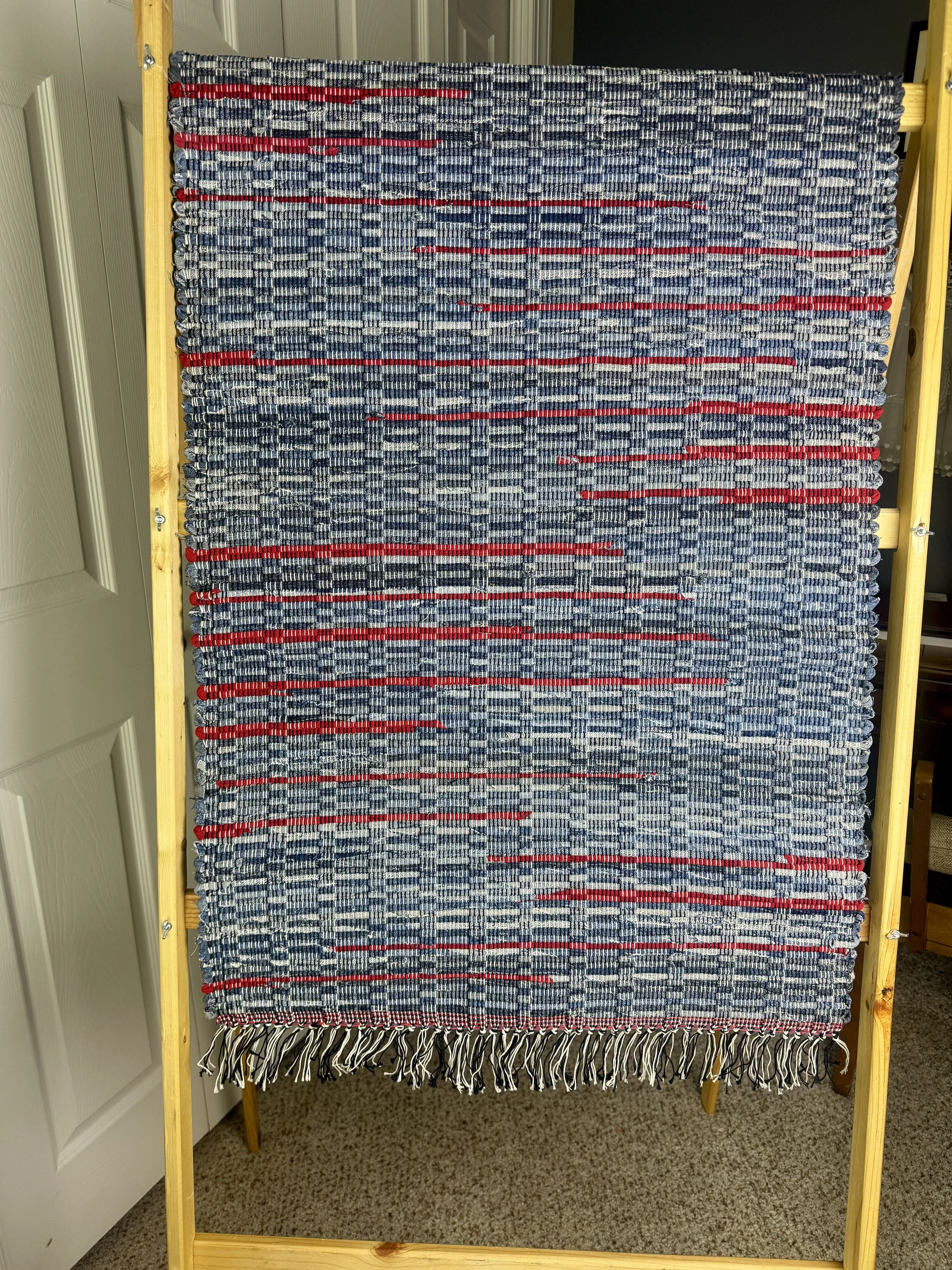 Hanging woven rag rug showing pattern