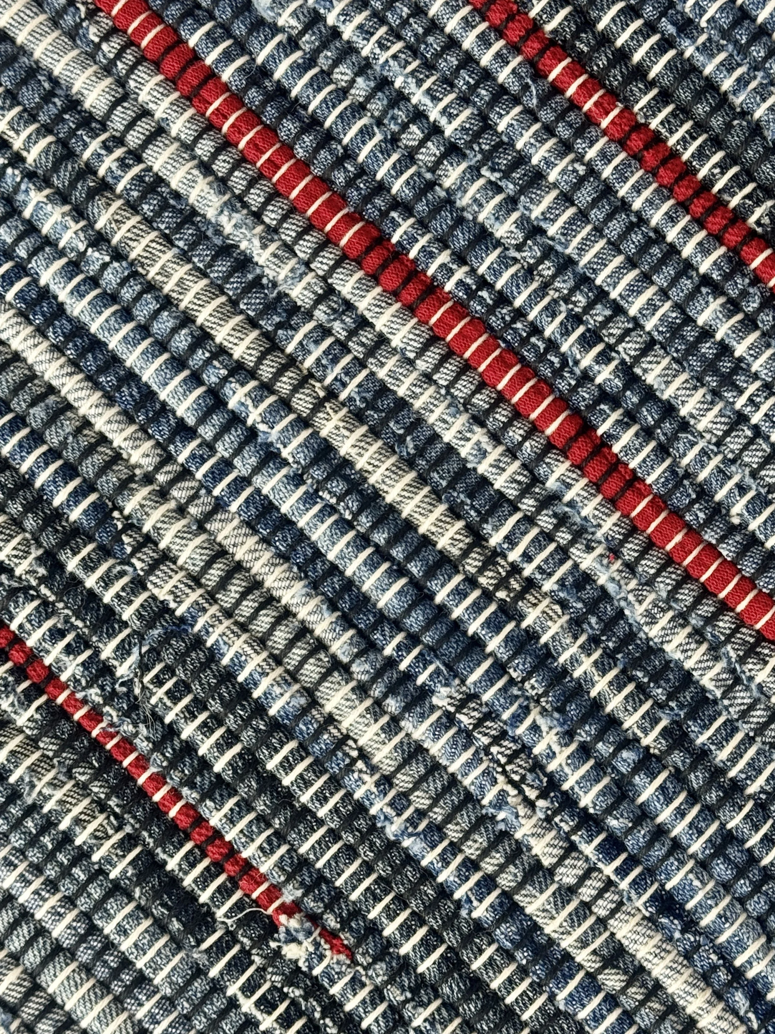 Close up handmade rag rug featuring texture and weave pattern