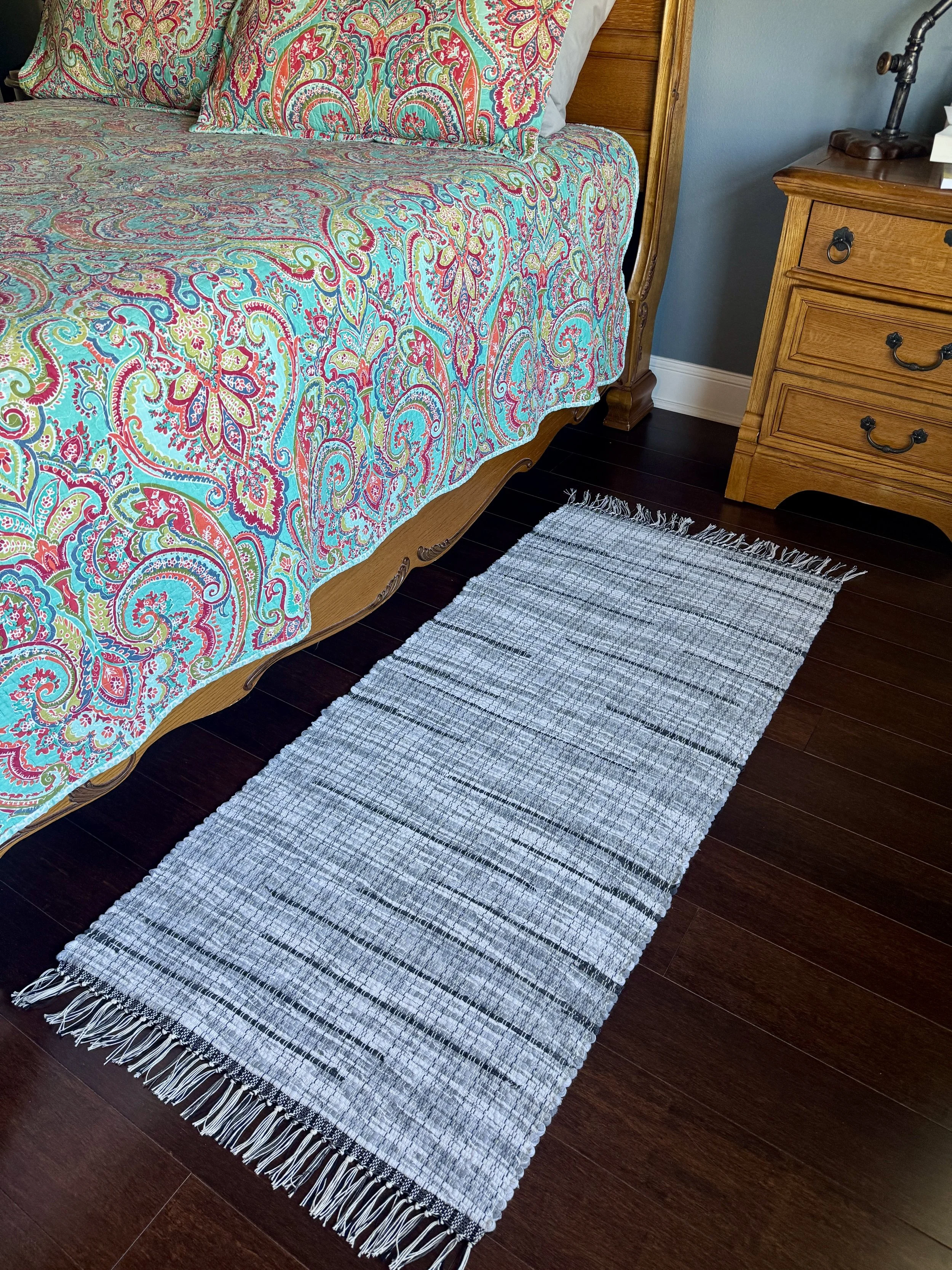 Displayed handcrafted rag rug in bedroom showing pattern