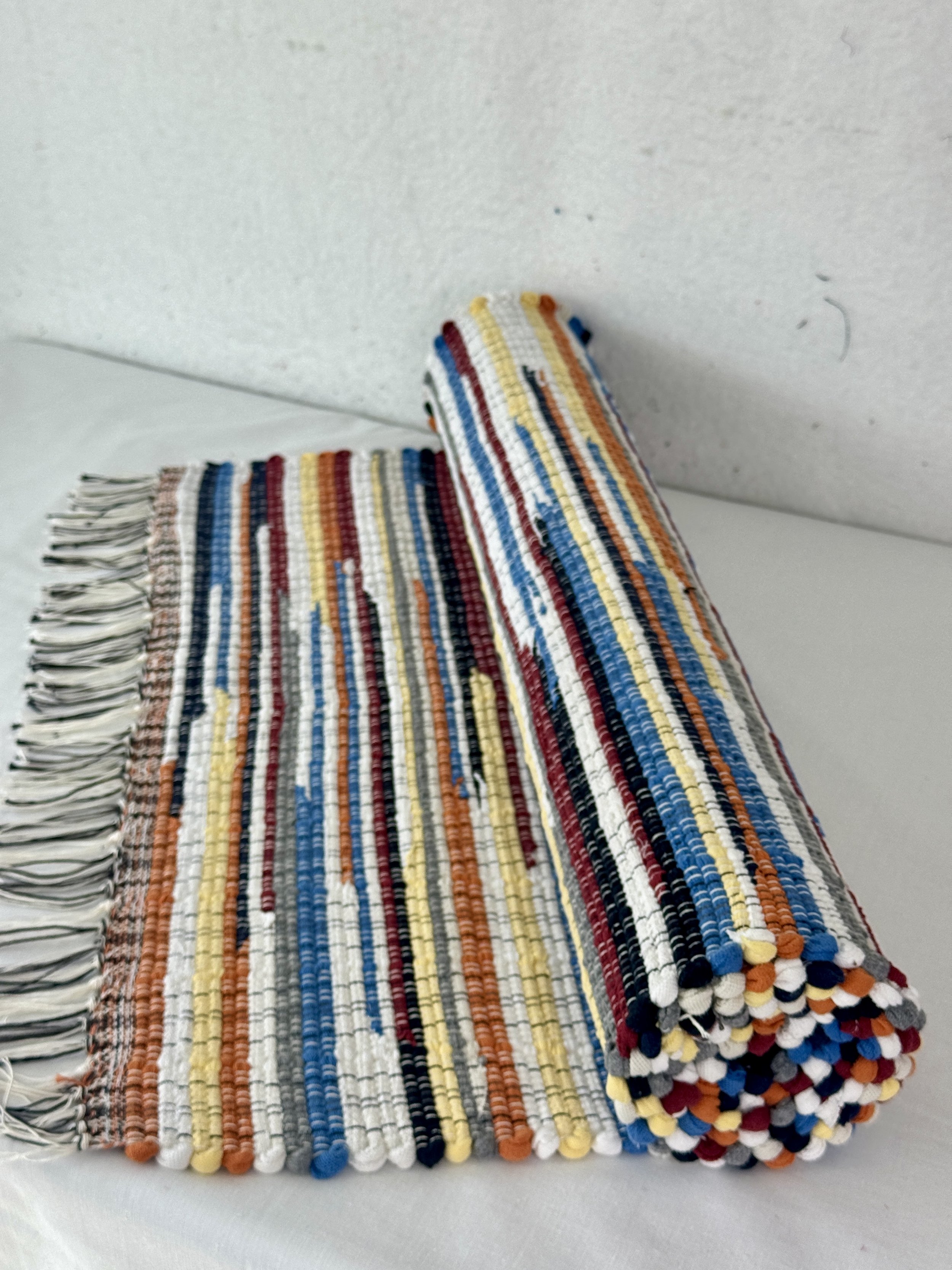 Handwoven white, blue, orange rag rug 25 x 66 woven with recycled textiles