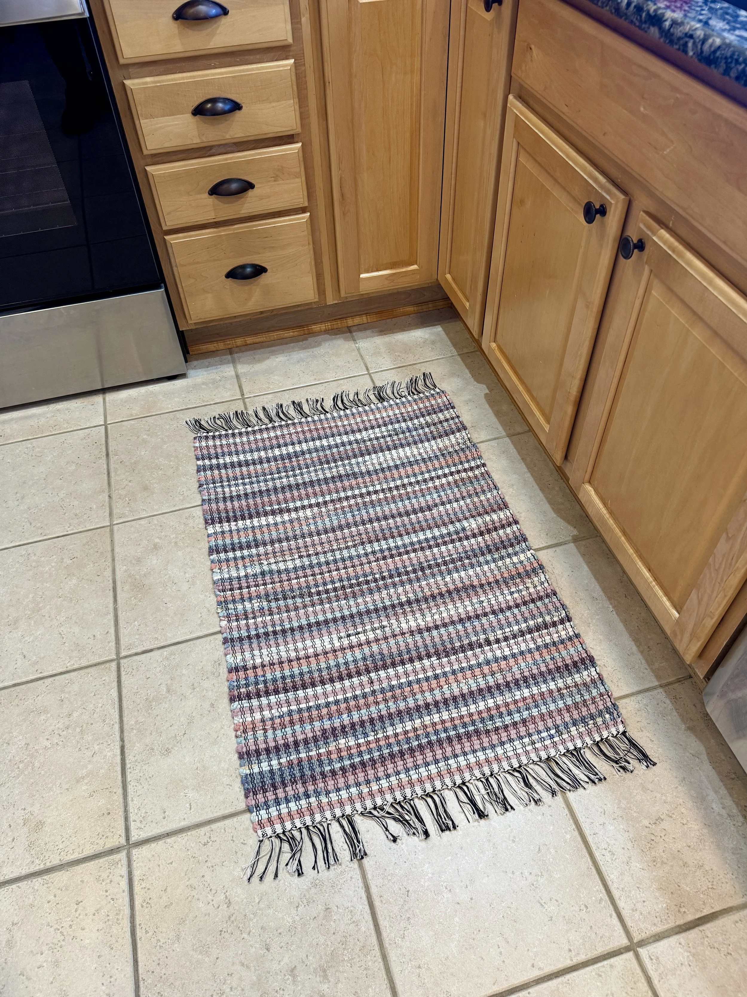 Displayed handmade rag rug in kitchen showing pattern and texture
