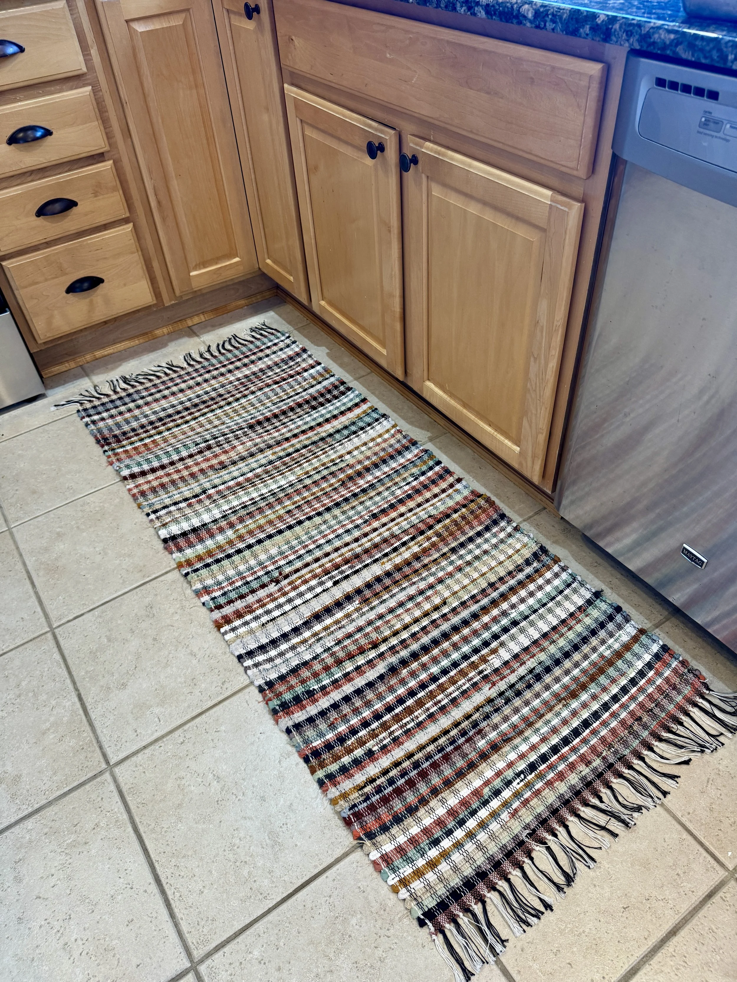 Handcrafted rag rug displayed in kitchen showing pattern and fringe