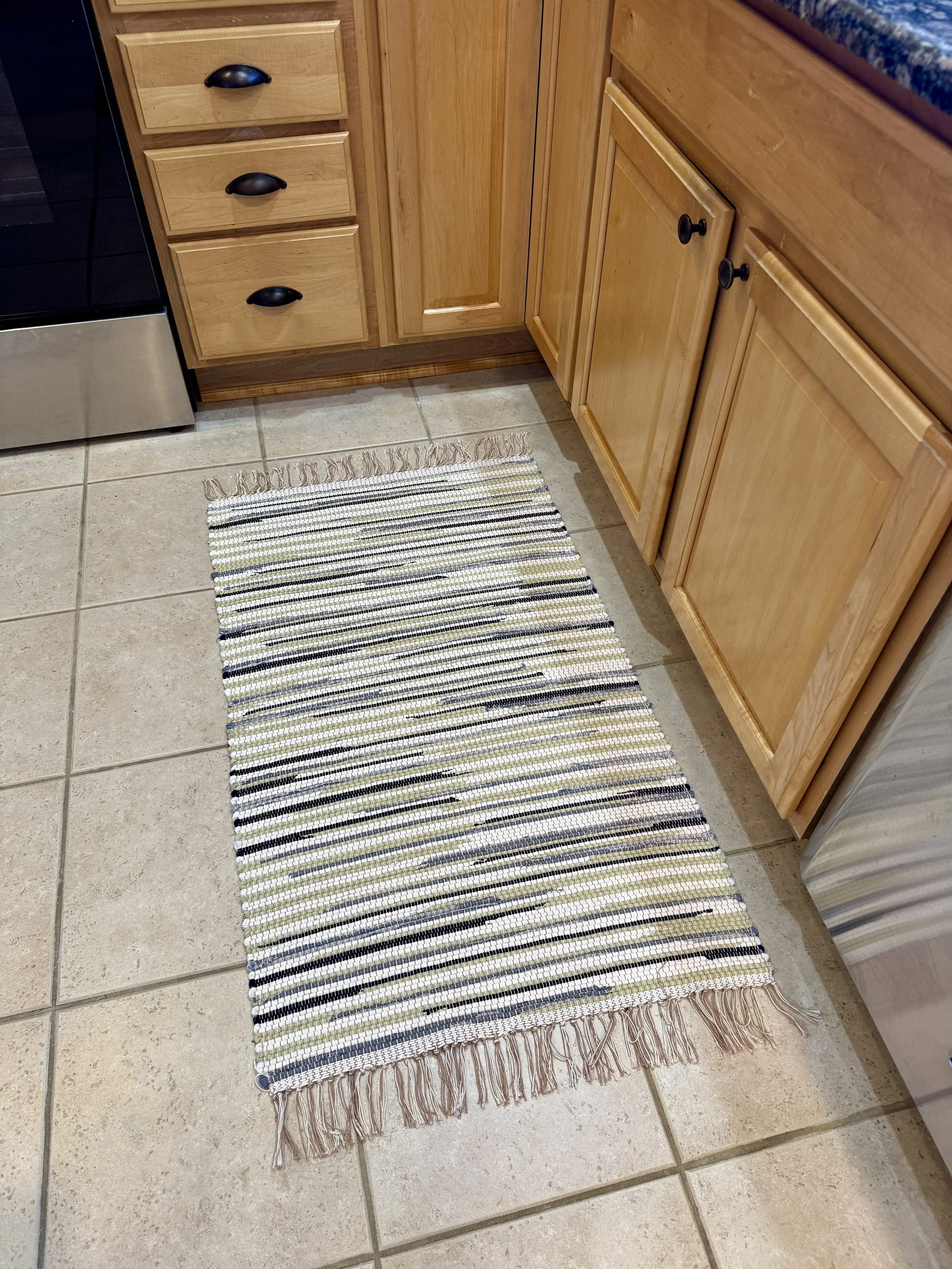 Displayed handmade rag rug in kitchen showing pattern and texture