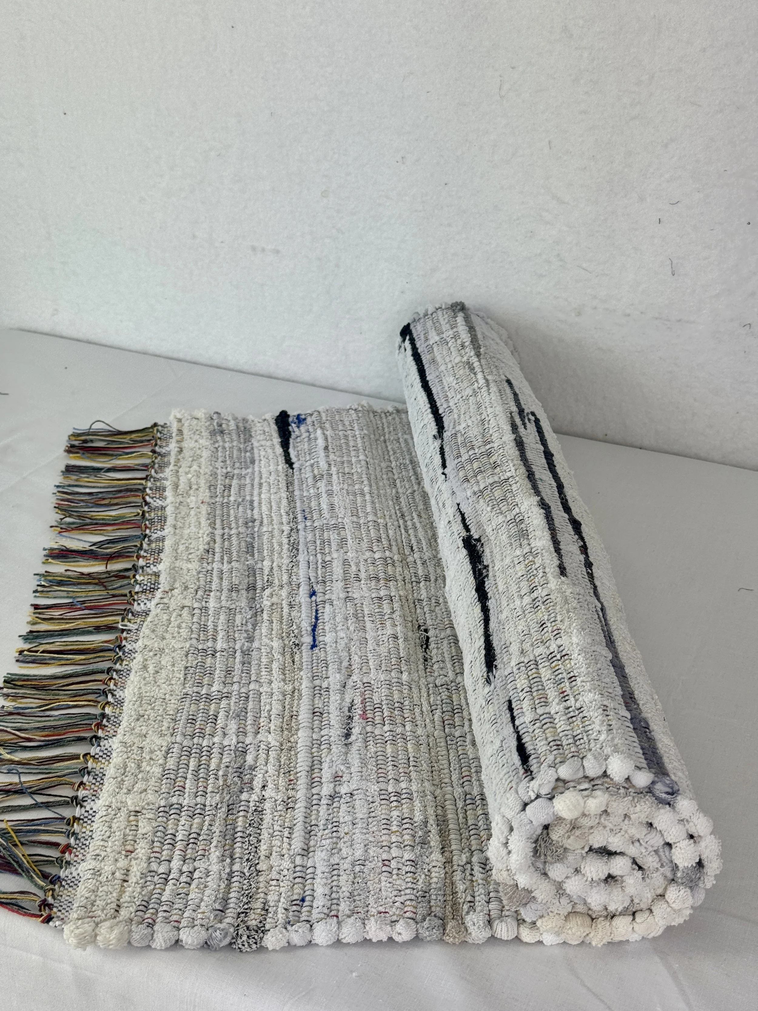 Handwoven off white rag rug made from upcycled socks