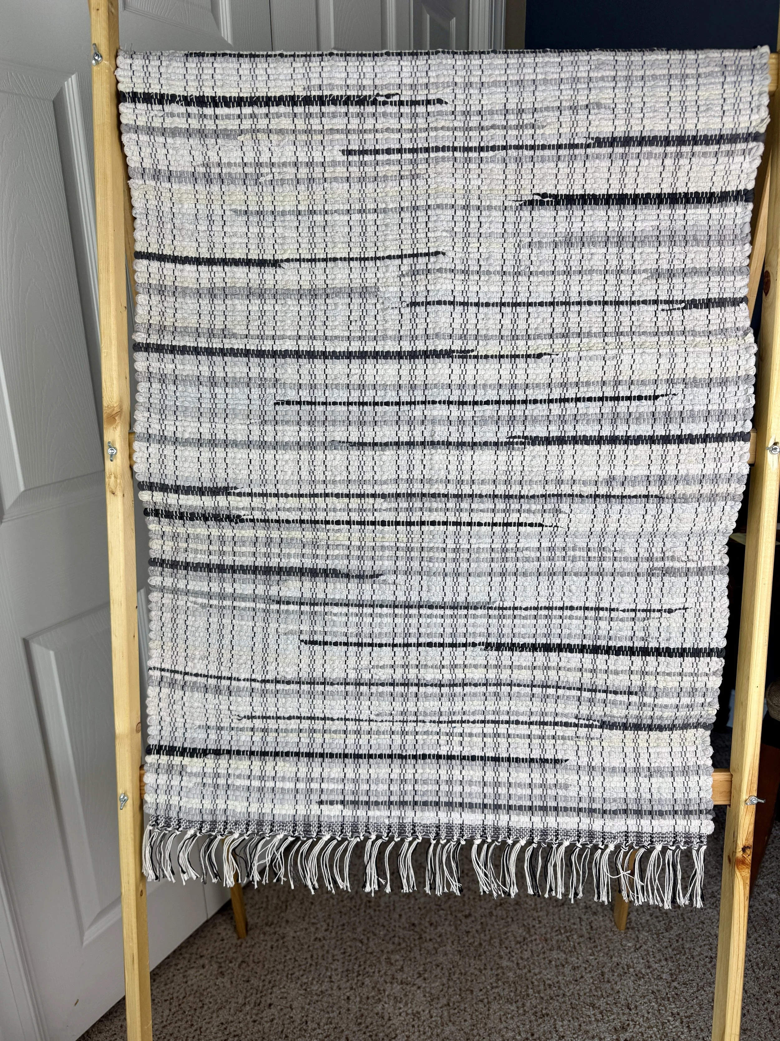 Hanging woven rag rug showing pattern