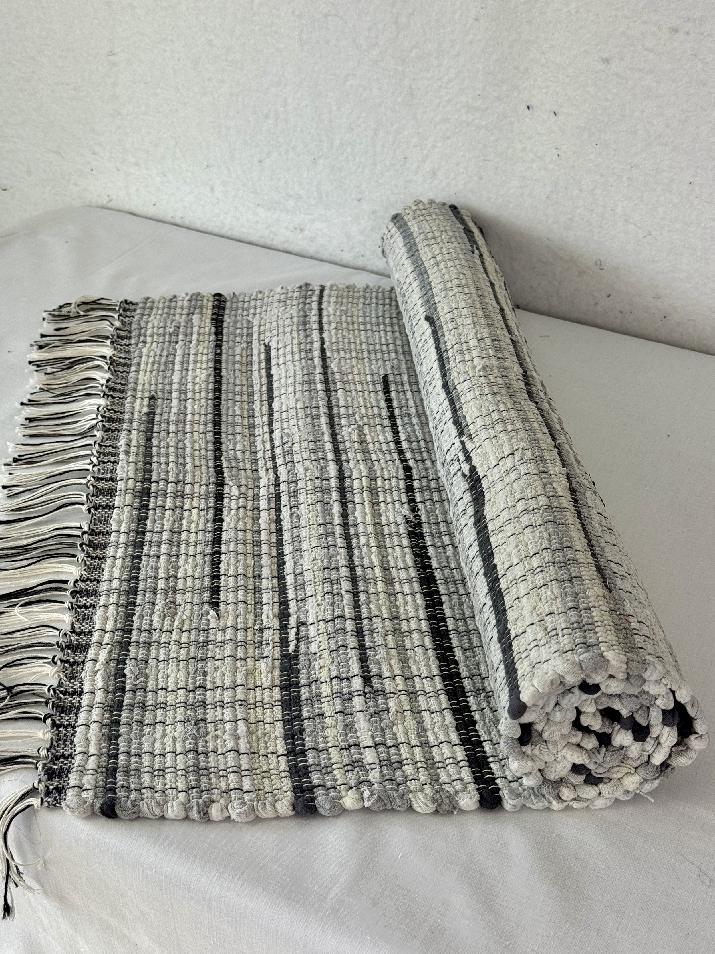 Handwoven gray rag rug 25 x 49 woven from recycled textiles
