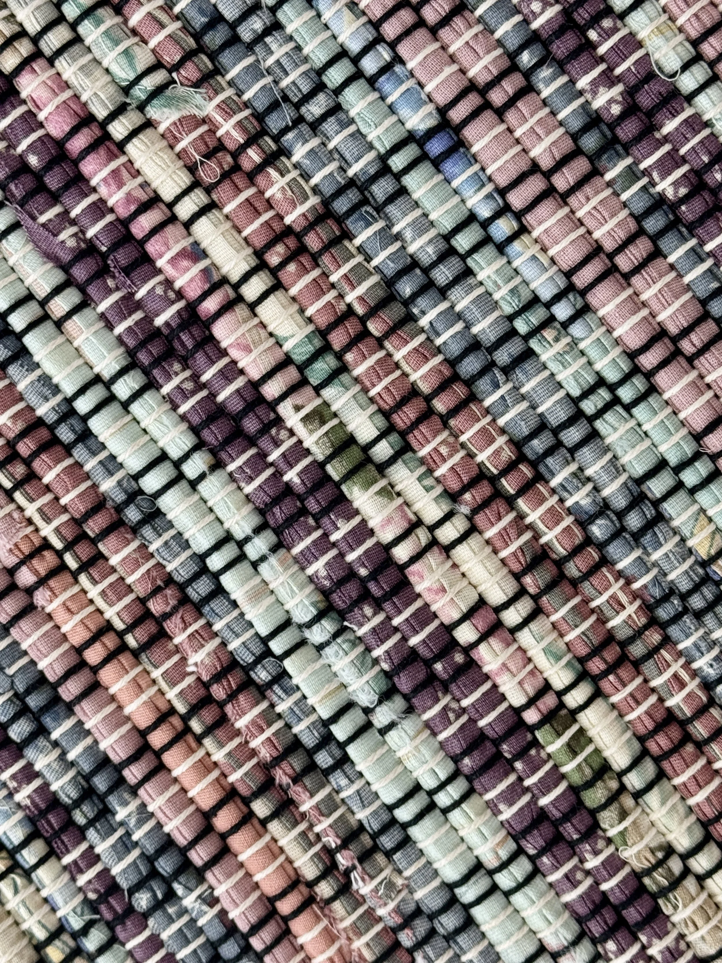 Close up handmade rag rug featuring texture and weave pattern of recycled denim