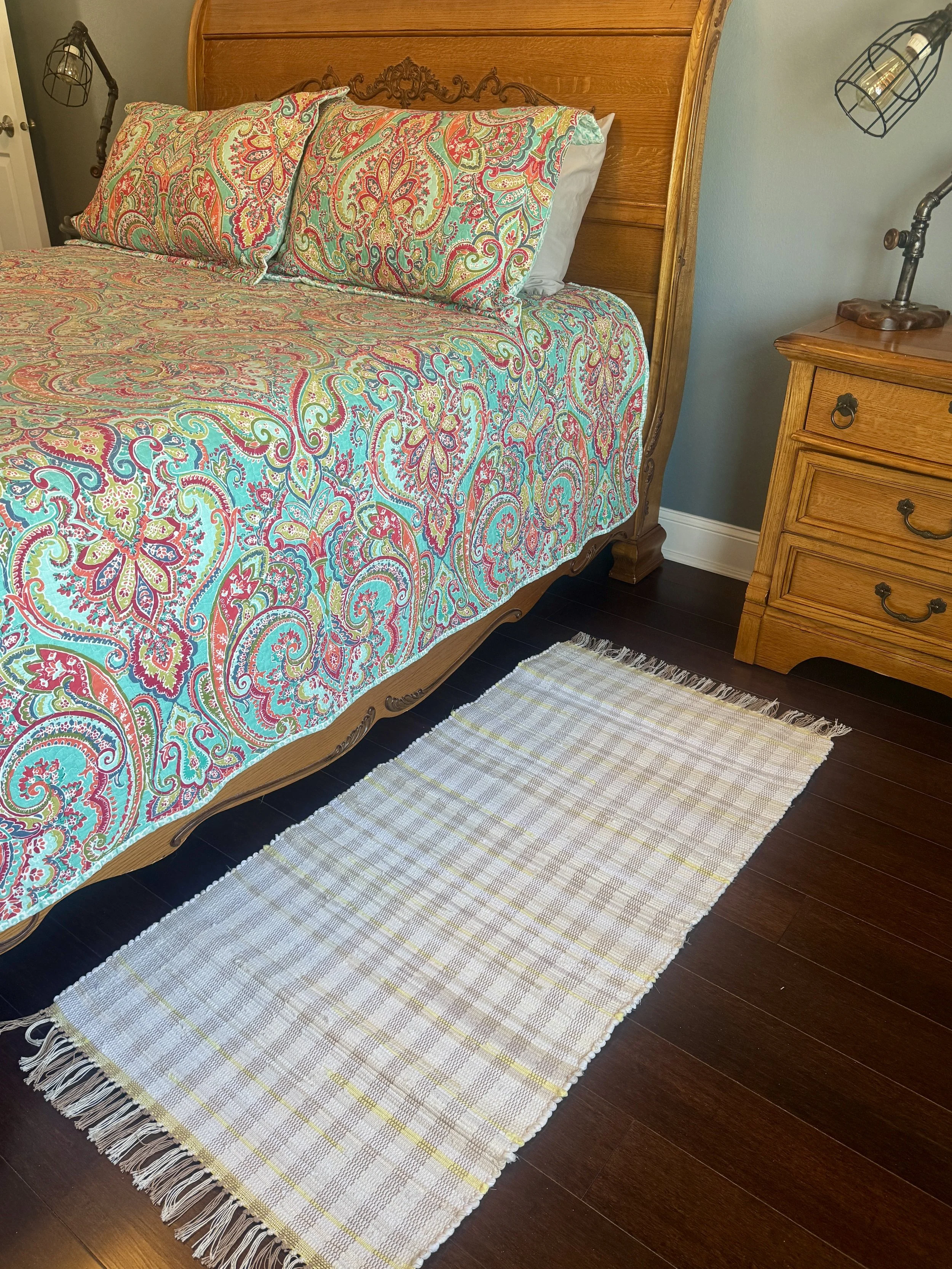 Displayed handcrafted rag rug in bedroom showing pattern