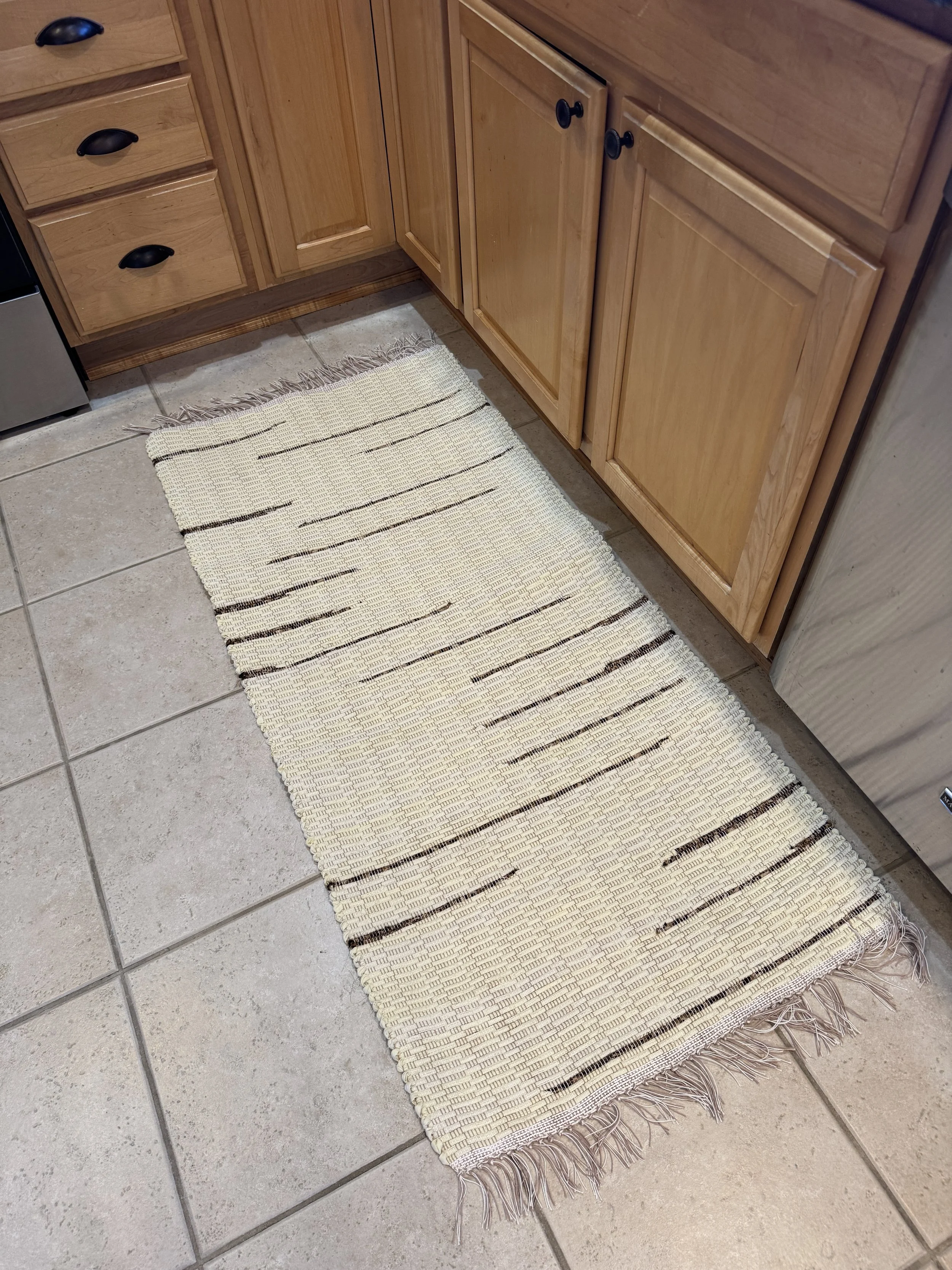 Cream Handwoven rag rug displayed in kitchen showing pattern