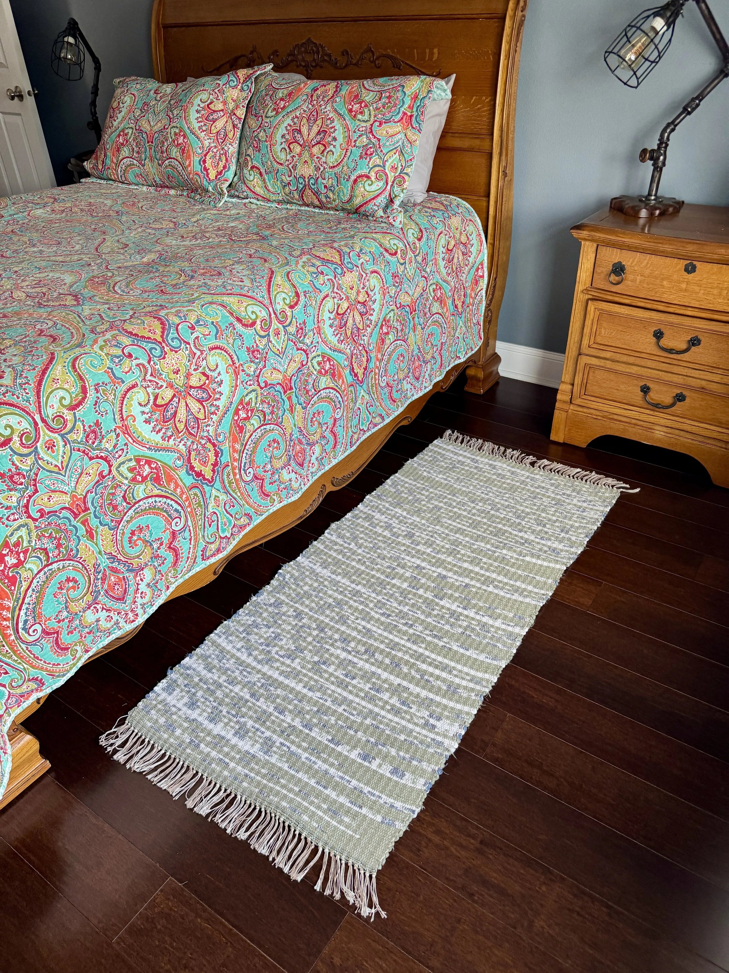 Handwoven rag rug displayed in bedroom showing pattern