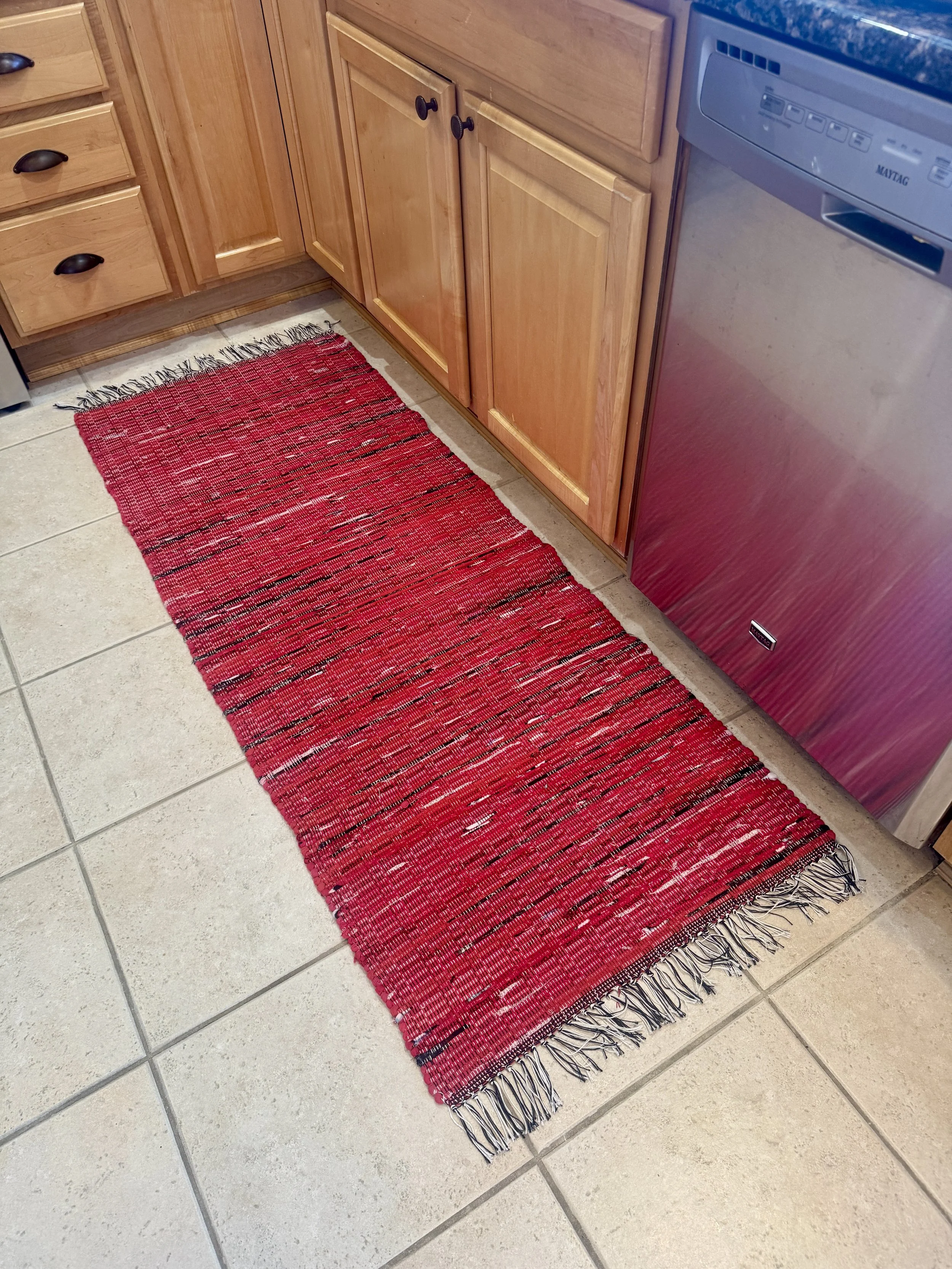 Displayed handmade rag rug in kitchen showing pattern and texture