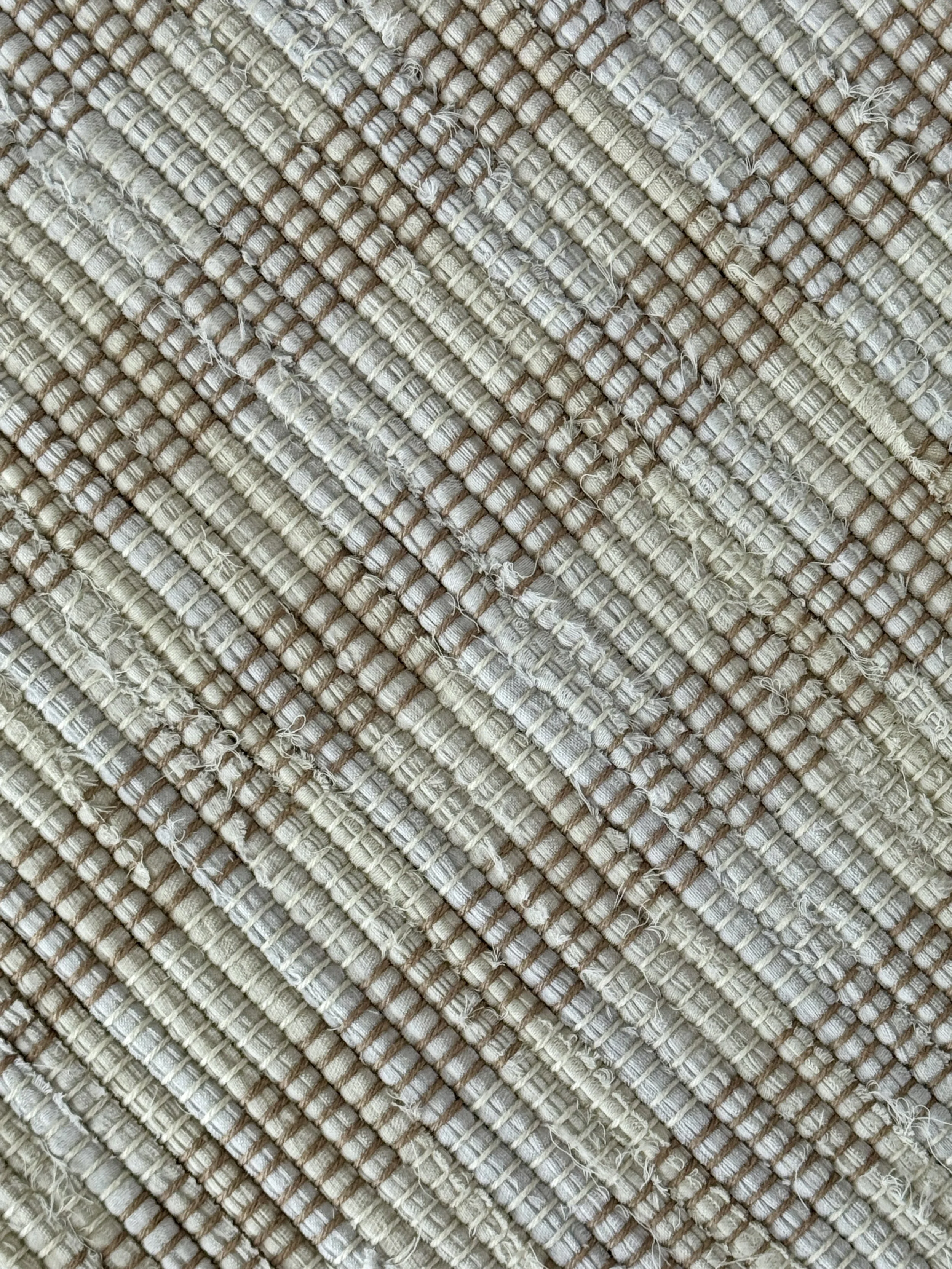 Close up handmade rag rug featuring texture and weave pattern