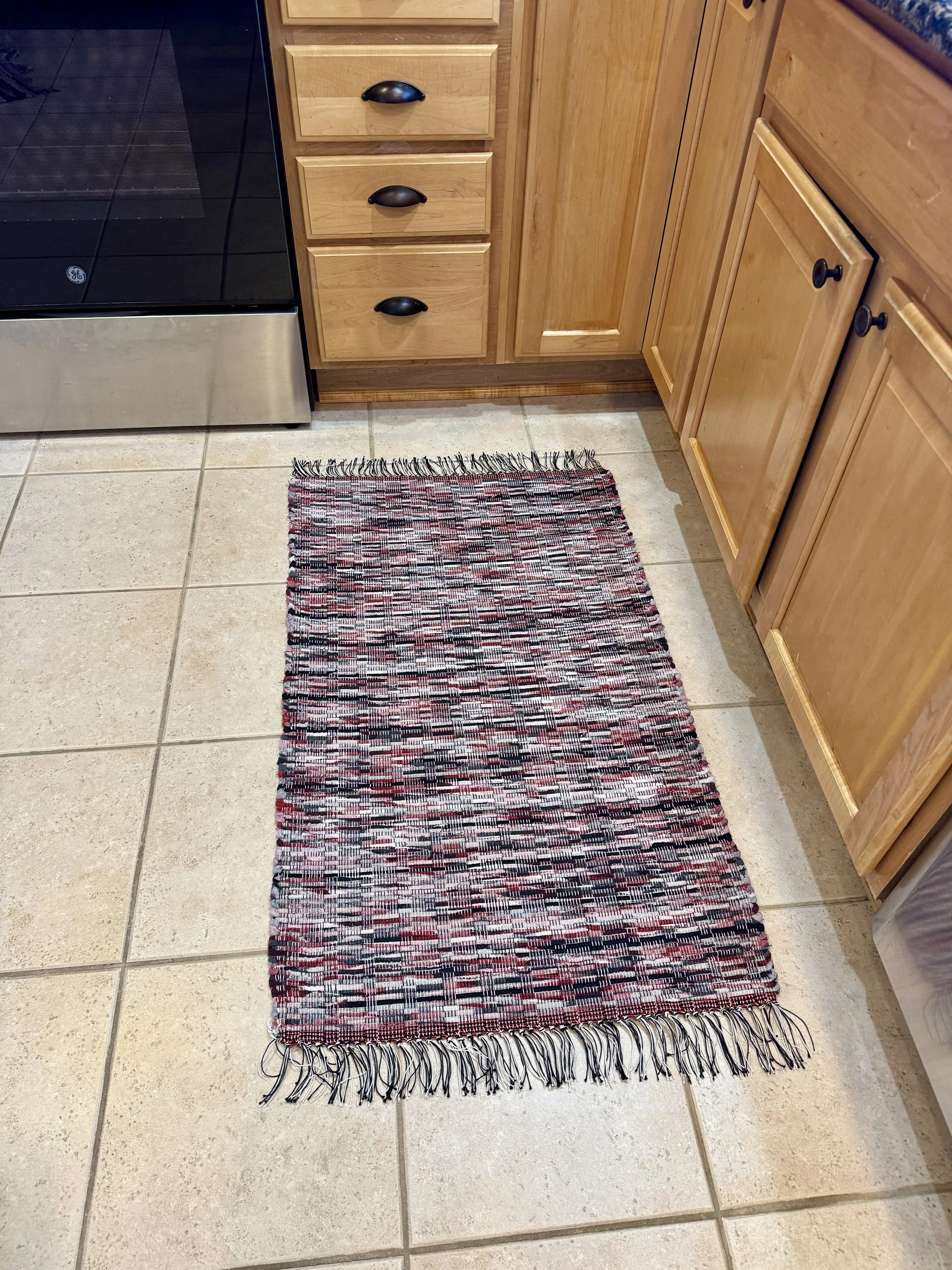 Displayed handmade rag rug in kitchen showing pattern and texture