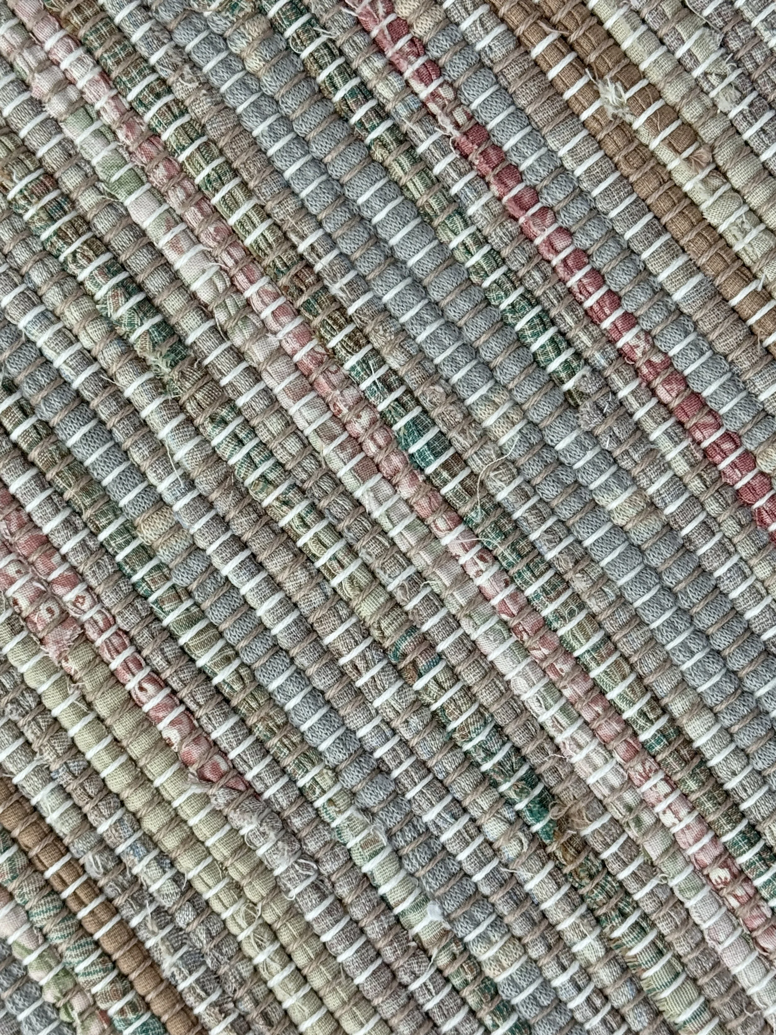 Close up handmade rag rug featuring texture and weave pattern